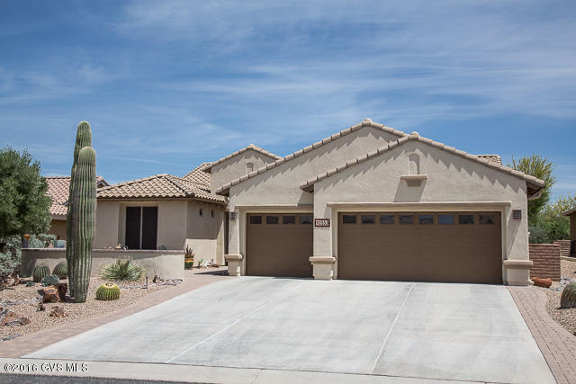 FANTASTIC PRICE for this UPGRADED home with 3 Bedrooms, 2 -1/2 Baths, Open Concept Great Room, Large Kitchen/Dining Area & 3 Car, EXTENDED, insulated Garage with Built-in cabinets & workbench. The home is located on a natural wash with a North facing back yard & offers lots of privacy & views of the Mountains! Inviting front patio with brick pavers greet you as you enter the home. The foyer has a coffered ceiling. The Kitchen has LOTS of Cabinets & Granite Counters. Gas stub behind the electric smooth-top stove. The master suite has a door to the back patio. Master bath has a soaking tub, separate shower, comfort-height toilet & a LARGE upgraded, walk in closet. Tile flooring thruout the house. There are two Guest Bedrooms  one currently used as an office. The Guest Bath has  sliding glass doors on the tub/shower & a comfort-height toilet. Ceiling Fans in all the bedrooms, Great Room & Dining Area. Beautiful window coverings thru out. Upgraded laundry Room with lots of cabinets & a sink  washer & dryer included! The Garage attic is floored with 50-60 sq. ft. of storage. Water treatment system, exterior painted in 2015, low voltage lighting, Gutters & solar screens on south & west facing windows.