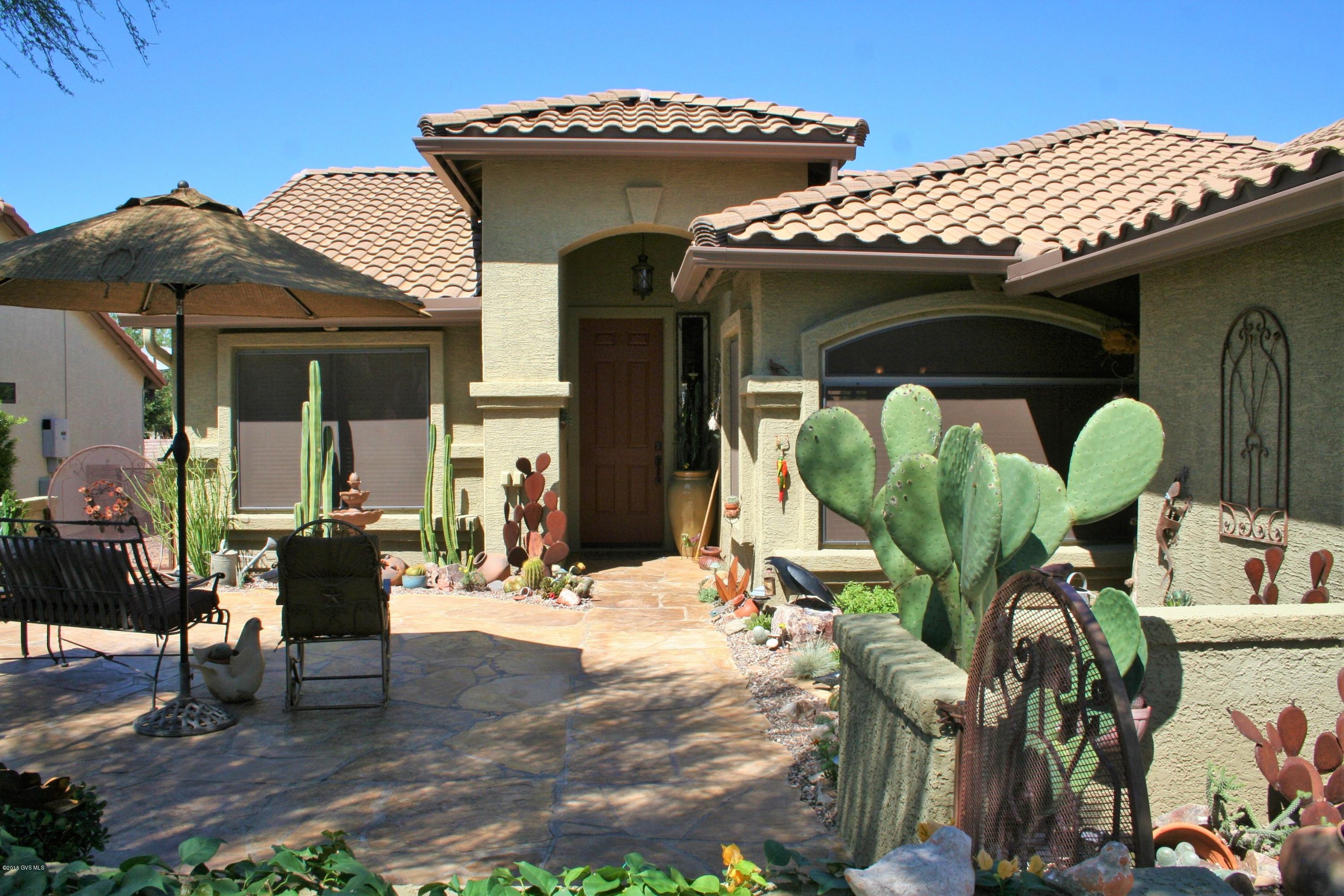 Over 1800 sq ft with 2 beds/2 baths and a den, this is one of the most elegantly and beautifully done homes in Quail Creek! Endless curb appeal begins with a perfectly manicured lot sloping gently up into the large front courtyard which showcases a custom iron gate, gorgeous flagstone and awe-inspiring desert gardens! As you step inside, impeccable taste and attention to detail are immediately evident, from the rich earth tone color palette to the pendant lighting and copper switch plates. The kitchen is luxuriously done and features a stunning dark granite slab island, warm brown cabinetry, granite sink, stainless appliances, golden glass tile back splashes, and a custom tiled breakfast bar. A shuttered bay window looks out to the cactus gardens and frames the dining area in the  kitchen Recessed lighting and warm toned ceramic tile showcase the living area, and creative accents include lighted art display shelving and designer window treatments with copper look valances. Stepping through the glass sliders to the back yard, you will discover an outdoor desert paradise! The covered patio is paved with rough edged brick and flows easily into the gazebo dining area. You will spend endless hours wandering through the cactus gardens, enjoying the artistic detail that has gone into every inch. On warm winter evenings, relax in the sparkling spool which is enveloped in privacy and surrounded by more spectacular desert gardens. A waterfall cascading into the spool adds to the peaceful ambiance. At the end of the evening, retreat to the serenity of the master suite