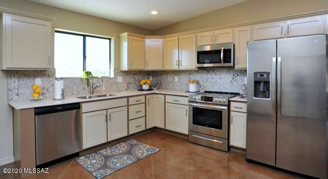New custom built home on 1 acre lot in Marana! 1500 sq ft with 3 bedrooms, 2 1/2 baths. Master suite has large walk-in closet and dual sink vanity. 3rd bedroom en suite with walk -in closet, 1/2 bath and outdoor access. 2 car finished garage, extended driveway, RV parking allowed, large backyard. Stainless appliances and quartz counter tops give the kitchen a designer look, with two toned custom cabinets and tiled backsplash. Very open floor plan with warm color pallet and beautiful scored stained concrete flooring throughout. New AC heat pump,  circulating gas hot water heater. Take advantage of the maintenance free Metal roof! WILL CONSIDER OWNER CARRY LEASE/OPTION!