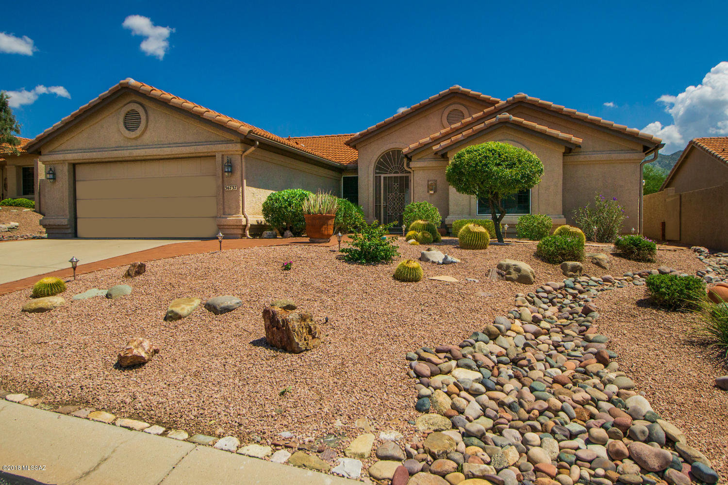 Magnificent East Mountain View from this 2 bedroom den Topaz Model.  Private patio with no neighbors behind.  Exceptionally well maintained, neutral & sparkling clean.  Newer exterior paint color, upgraded front door.  Low care landscaping, brick walk, screened entry.  Extended brick patio, patio lights, stucco rear wall.  Built in storage in garage.  Tile in all the right places, Plantation Shutters on windows, ceiling fans in Family Room Master Bedroom & Den, custom guest closet.  Kitchen features gas range, microwave, roll-out shelves.  Solar tubes in Kitchen & Guest Bath.  Great Home!