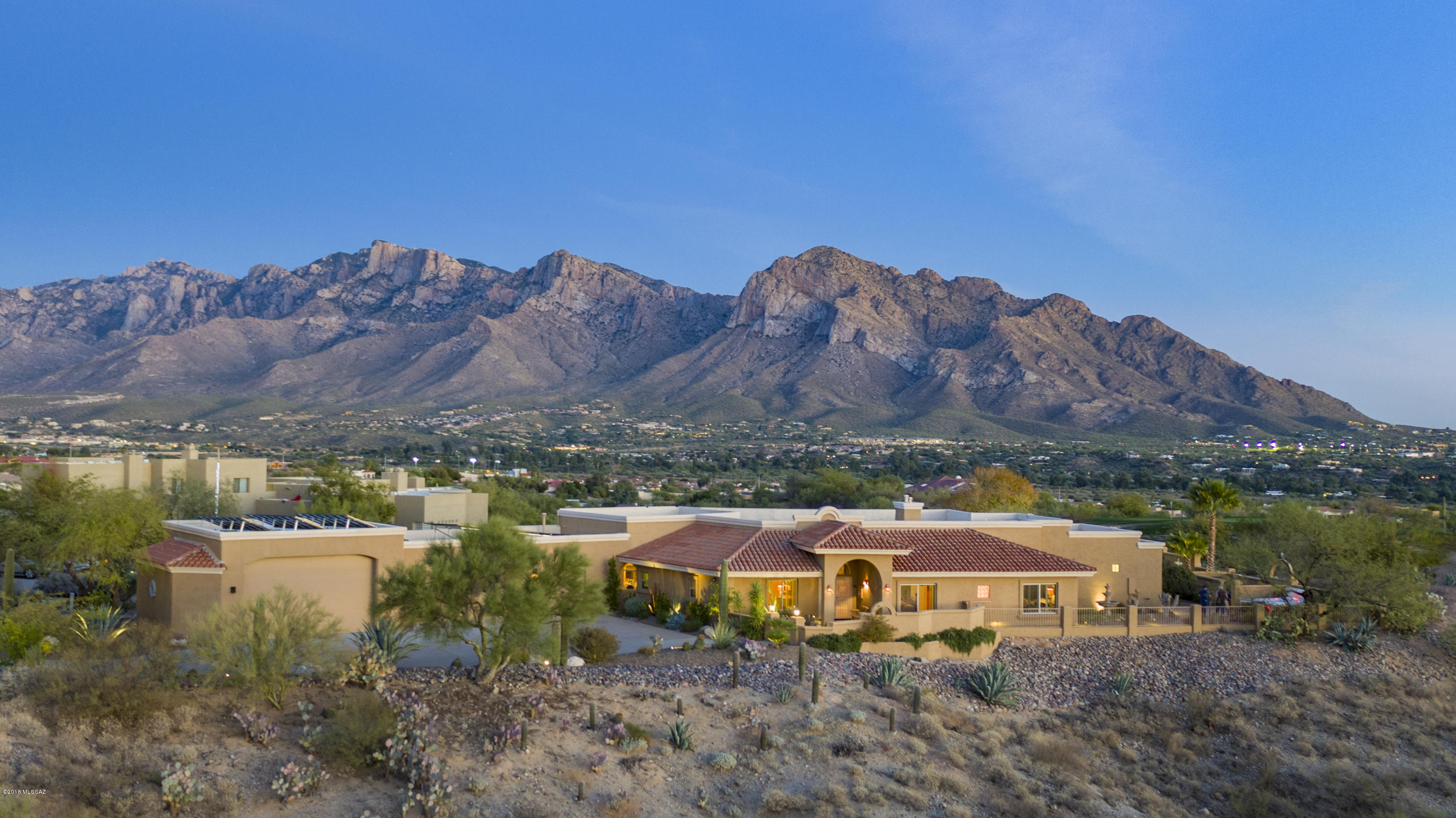 Possibly Best Catalina Mountain views in all of Oro Valley! Gated Canada Hills  Estates single story 3,535sf, 4BR, 3½BA w/unobstructed panoramic Catalina Mountain views from inside & out. Car collector's garage accommodates 10+/- cars w/innovative two-tier parking and/or RV. Driveway & Garage engineered for Exotic Cars. Mediterranean style home combined w/Southwest flavor on 1.5 acre private premium ridge lot overlooking El Conquistador Golf course, unobstructed Catalina Mountain views w/picture perfect views from every room. Heated pebble tec pool/spa. Gourmet kitchen has granite counters, stainless appliances. Family room off kitchen. Formal Living/Dining Room. Spacious Master suite w/updated bath, walk-in closet. Solar sun shades & 40 Solar Panels on Roof  for very Low Utility Bills.