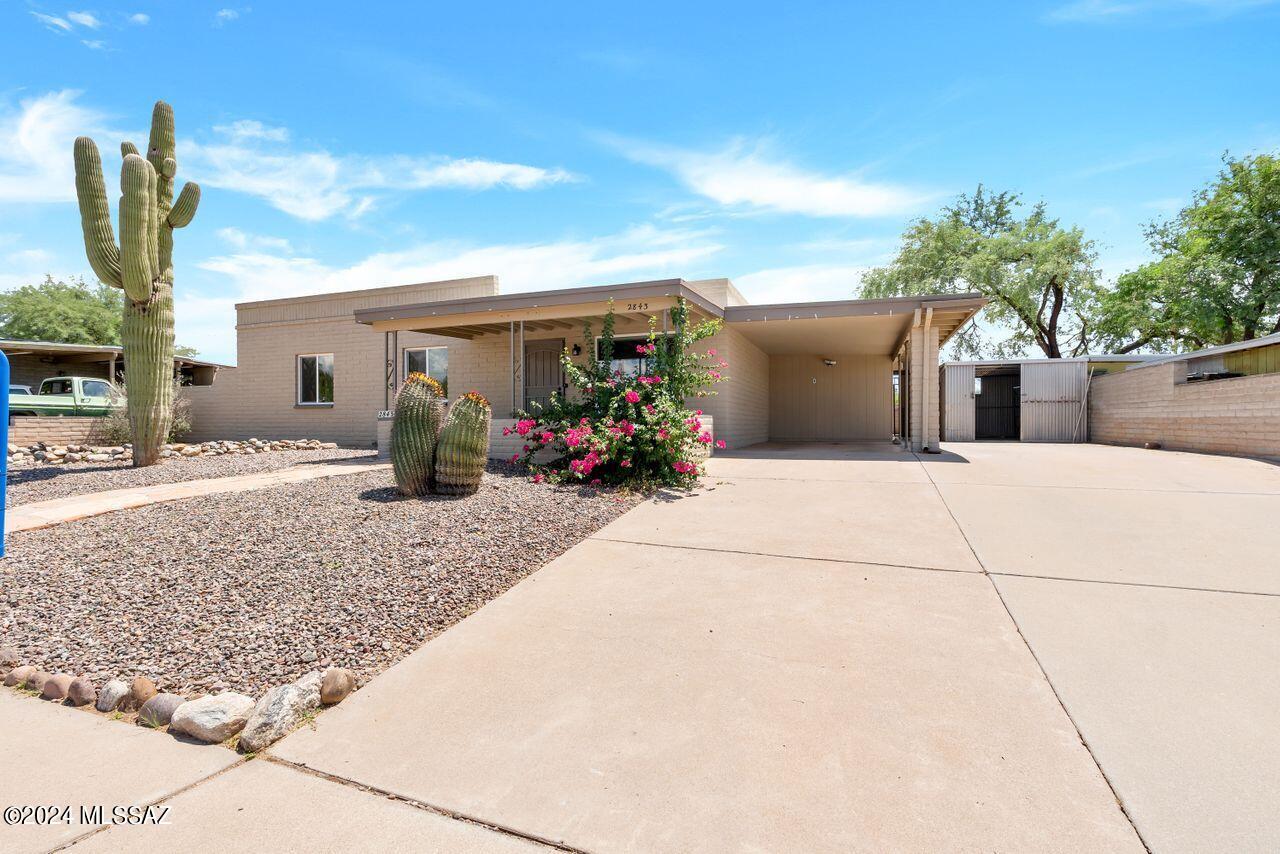 BEST KEPT SECRET  This prime location with updated 3BR 2Bth backing up to large open common area giving you privacy and views, and with easy access to all points where shopping, restaurant, schools, I10, are all within a few easy minutes away.  This is a well cared for home that was completely rehabbed by the owner to his standards a few years ago and has a beautiful kitchen with patio doors and windows looking out into a huge yard that is waiting for your discriminating landscape design that will add on to the paver patio that already exists. Carport and storage building give you room for your stuff.  Flooring is lovely new linier wood  throughout, appliances, bathrooms and all 3 bedrooms have been updated.  This home is move-in ready and cute as can be.  Go and show.