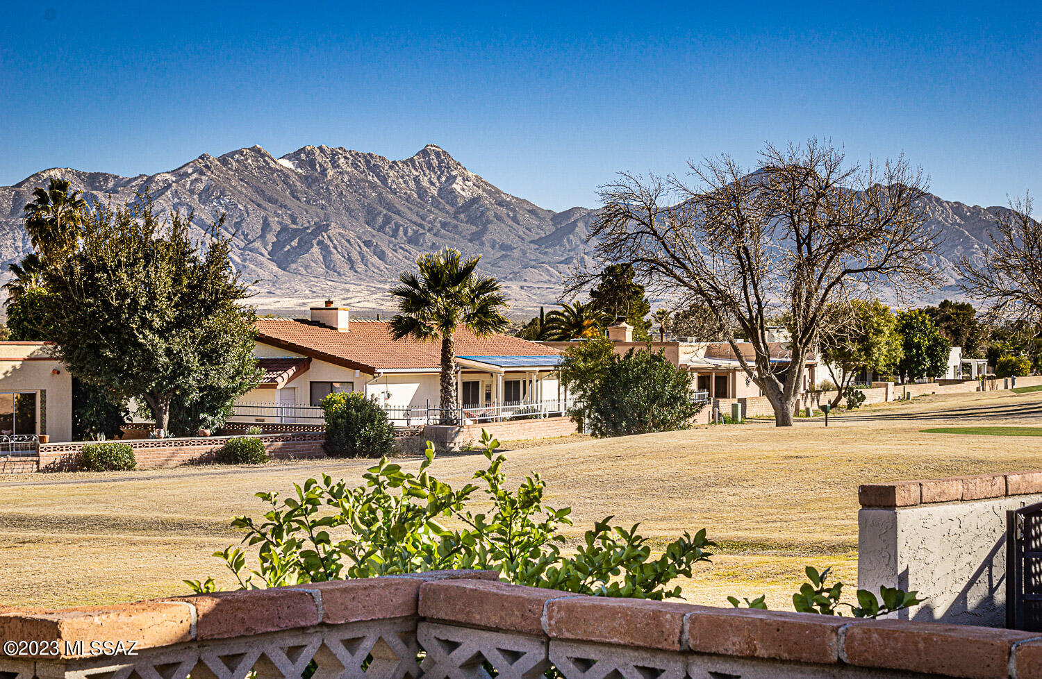 Enjoy the Green Valley Lifestyle in this BEAUTIFUL APPOINTED home with BREATHTAKING  VIEWS OF GOLF COURSE AND SANTA RITA MOUNTAINS. NO GVR - BUT AVAILABLE. Spacious and inviting floor plan offers 3 Bedrooms, 2 Bathrooms, Bonus room, AZ room and large 2 Car Carport. Living/Dining area with beehive fireplace and engineered wood flooring that open to an expansive Arizona room giving extra living space. Kitchen with tile counters, Stainless steel appliances, plenty of cabinetry, modern backsplash and large breakfast nook. Owner's retreat offers double closets and a bathroom with a walk-in shower. Additionally find 2 good size bedrooms and a guest bathroom with shower/tub combo. Bonus room is perfect as an office or hobby room. RELAX and ENTERTAIN at the low maintenance backyard with a gorgeous Golf course (18th fairway lot) and Mountain views. Extra features include, newer windows, fans in all rooms, storage shed and modern paint palette . LOW HOA ONLY $36/Year. All around a fantastic home that has a lot to offer and you can't miss. Age restricted 55+ Community.