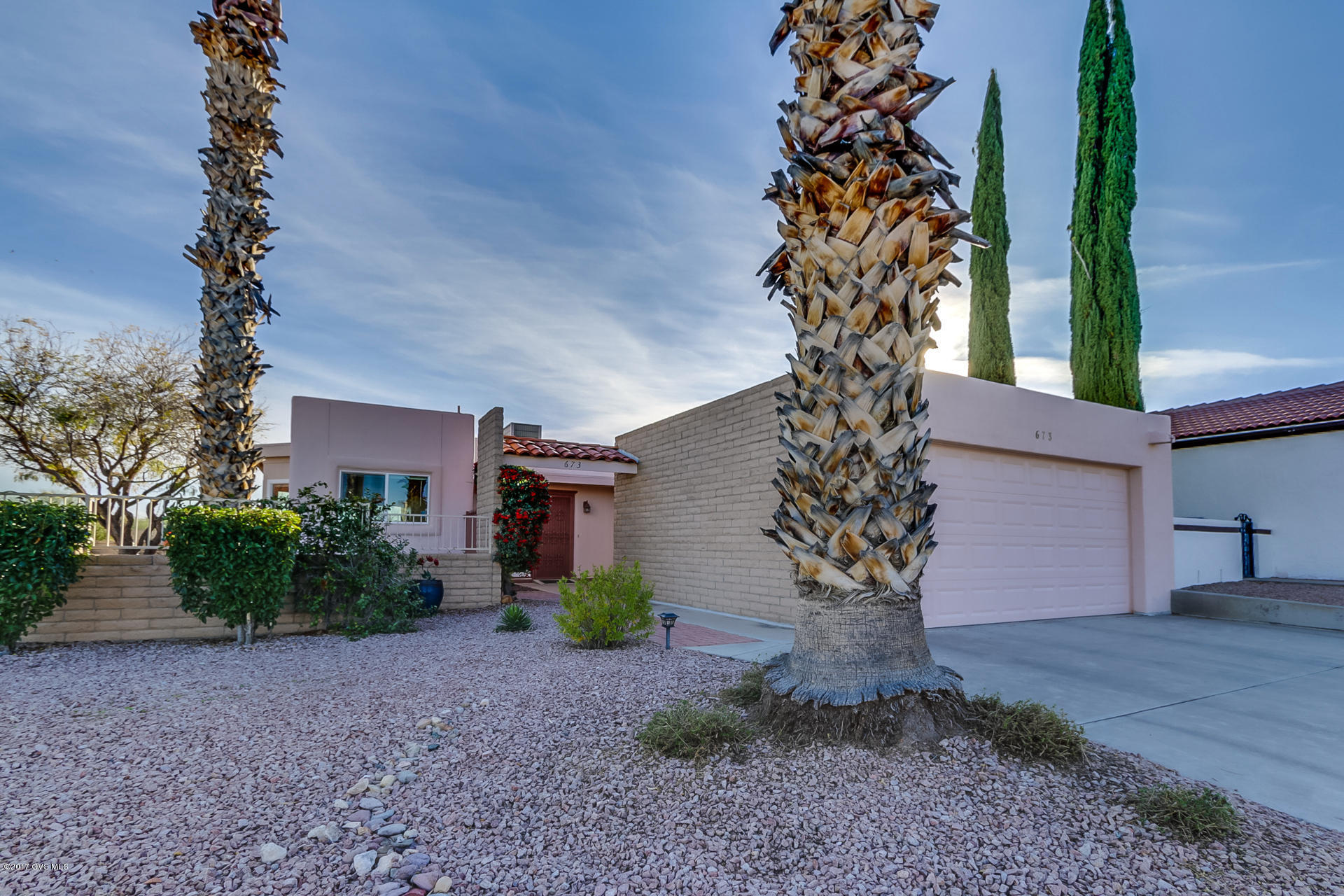 Come take a look at the amazing transformation in this beautifully updated home located in The Villages. When you walk into the open airy floor plan you will immediately notice the extensive use of windows and sliding patio doors that draw in the inspiring outdoor scenery with views of the Santa Rita Mountains. Carefully dressed in a soft color scheme, the peaceful living room opens to the dining area for the updated great room feeling. The kitchen's spice stained maple cabinetry and sand tone tile floor convey an elegant contrast to the clean white appliances and extended countertops. Plus, a custom designed curved eat-in snack bar is wrapped by charming bay windows. Your master bedroom sanctuary offers sliding doors onto the private back patio. And, the upgraded master bath features  a plate glass shower enclosure with floor to ceiling custom tile work, a beautiful solid quartz vanity countertop with dual under counter basins and contemporary plumbing fixtures. The guest bedroom doubles as a quiet den perfect for relaxing with a favorite novel or catching up on some bookkeeping or computer work with built-in desk area. Step out onto your back patio and take in the endless desert vistas with the Santa Rita Mountains as a scenic backdrop adorned with colorful native shrubbery. A real gem that has a shining polish!