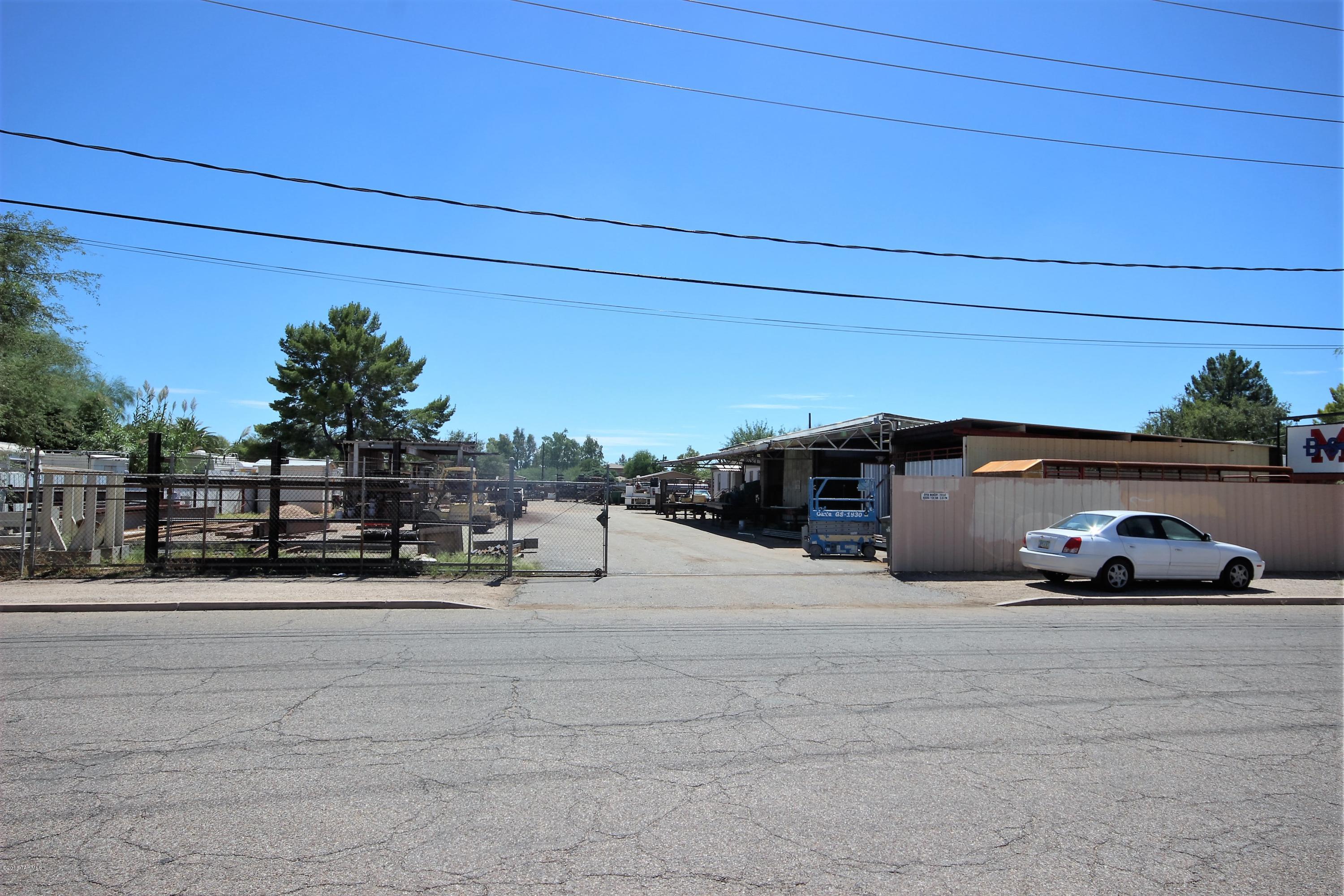 Almost one acre of commercial/industrial property (covered by non conforming use permit) in a great, accessible in town location. Two original concrete block buildings and a 14'x52' (GE 2007) office trailer, which is included as personal property. Large shaded work areas and other structures remain. Air conditioned office trailer, shop is evap cooled. All machinery and equipment will be removed. This offering is for two lots: 111-06-0250 and 111-06-0260, lot size and taxes reflect both. Alarm As Is.