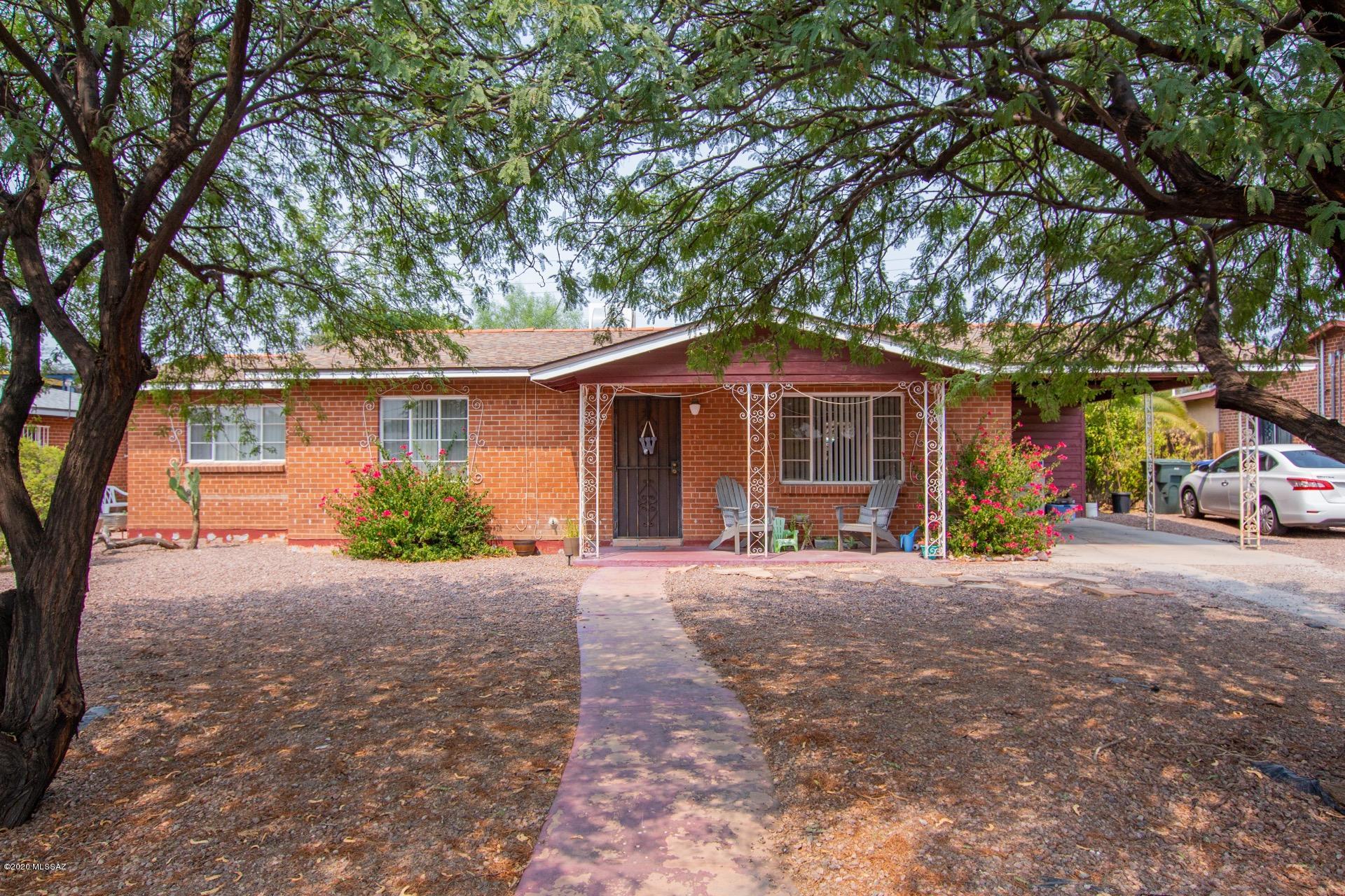 Take a look at this charming brick ranch style home! Beautifully maintained w/tiled & concrete floors, window blinds, & upgraded lighting. Pristine retro kitchen features tiled counters/backsplash & plenty of white cabinets w/hardware. Generous sized bedrooms, ceiling fans, & soothing palette. Huge backyard boasts a covered patio, outdoor laundry area, shade trees, & room for a pool, garden, & toys! NO HOA. Will not last! *Appt required; Tenant Occupied.