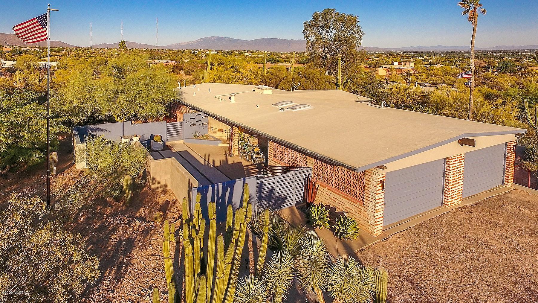 Gorgeous Mid-Century Modern home w/ spectacular setting! Glorious views & Rustic Charm make this an amazing opportunity! Perched on a hilltop Acre in beautiful Flecha Caida Estates, this 1958 classic Tucson Foothills property offers tremendous lifestyle. Multiple patios offer privacy, views & endless fun! Tastefully re-modeled w/ polished concrete floors & endless custom touches. Re-designed kitchen w/ Professional grade Frigidaire Fridge/Freezer, Marble Backsplash & trend Master bathroom offers Steam Shower & Jacuzzi tub.. Delightful floorplan flows easy & captures amazing views of the desert scenery. 3 Bedrooms 2 full bathrooms on main floor. En-Suite Guest quarters are poolside on lower level. Oversized 2-Car garage. World-class dog run on East side.. Newer HVAC, Windows & Sliders.