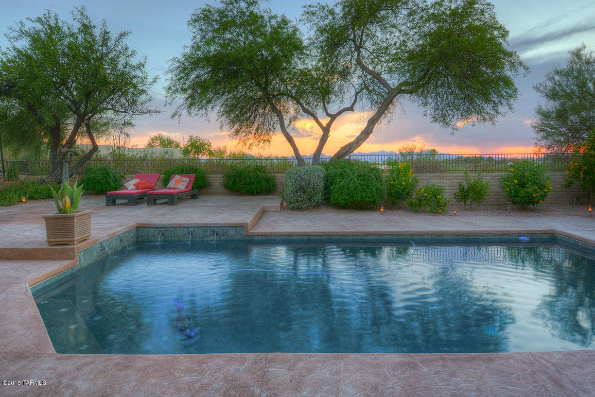Amazing views from this hilltop house on over 2 acres. With 4 bedrooms and a den, the home is bright and open. Kitchen is newly remodeled with wood floors, stainless steel appliances and silestone counters. Huge mastersuite with spacious walk-in closet and French doors leading to patio. Nice den or exercise room off of the garage. Resort like backyard with privacy and views of mountains and city lights along with pool, spacious patio and grassy area.