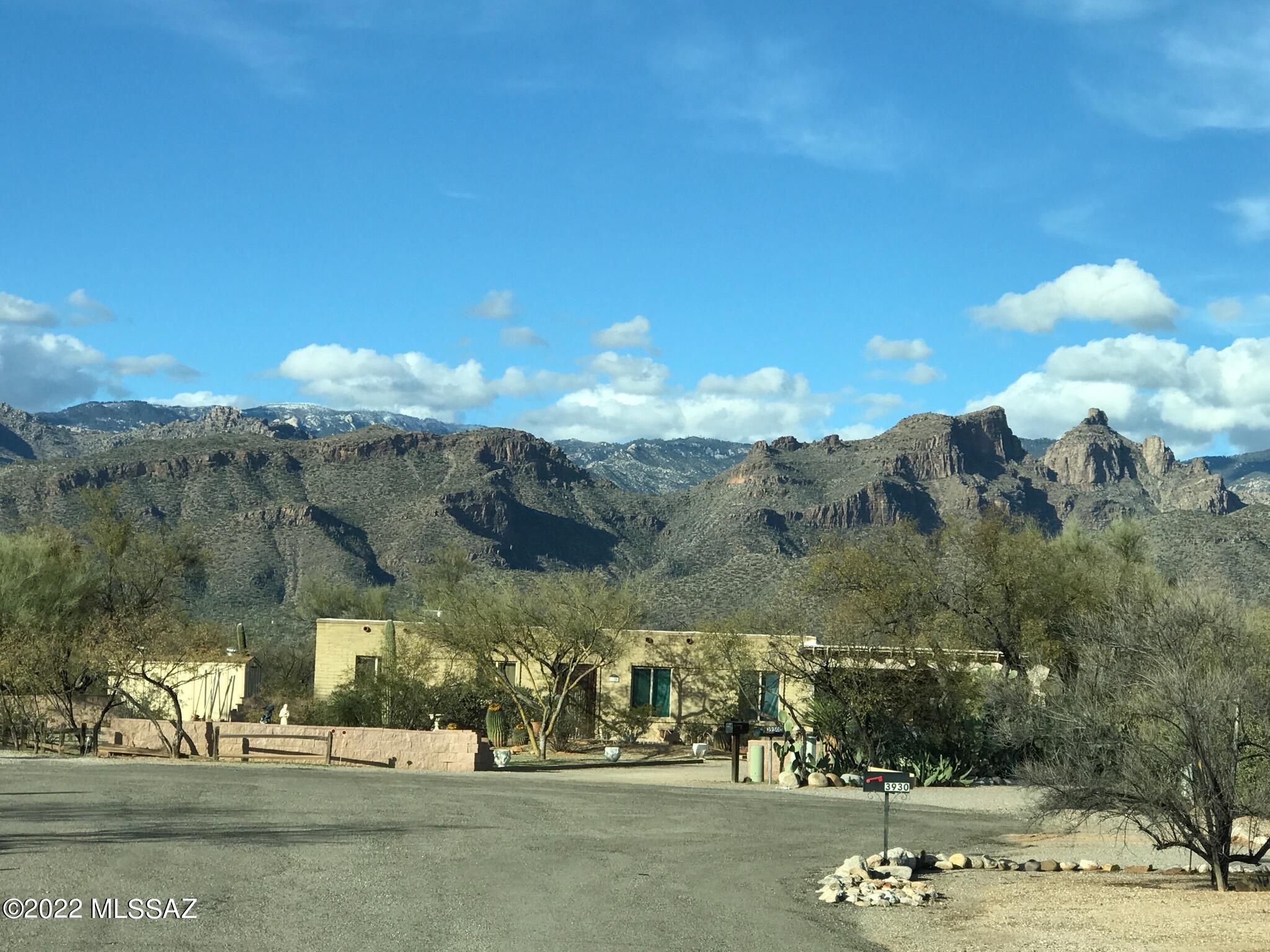 Enjoy privacy & wide open spaces nestled at the end of a quiet Cul-de-Sac. Solid brick cutie on almost an acre! Enjoy unobstructed Catalina Mountain views from your shaded brick patio along with the Sparkling Pool which was re-plastered in 2017. A lush wildlife/riparian corridor borders the North end of the property and can never be built on. *No HOA* so bring your RVs!  Living room has a cozy Beehive fireplace for those chilly winter nights. Kitchen features newer cabinets & granite counters along with a new sink, disposal and stove hood. Dual pane windows & roof was just re-coated. 1/2 bath in the storage rm off carport. Home needs new flooring. Seller has removed old tile from kitchen and will let new owner replace it to their taste. Seller will review all offers on Sunday Jan 23rd. Kitchen has no flooring...concrete is exposed.
Seller will consider credit to replace with good offer.
Washer/Dryer, Fridge and living room blinds Do Not Convey.
Low walls made of concrete blocks are not permanent/cemented in.
Seller may sell the materials before COE, or may leave with good offer if Buyers want them.
