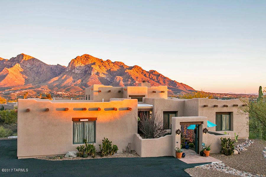 ''Right Out Of A Magazine'' This Lovely Santa Fe Home Has The Most ''Amazing  Pucsh Ridge Mountain Views''  You Can See The Views While You Enter Into The Private Courtyard. This Home Was Custom Built For The Builder And Has So Many Amazing Features Which Include Newly Painted Interior/Exterior, A Fabulous Cedar Beamed Ceiling With 1 Of 2 Lovely Custom Painted Gas Fireplaces,  Really Awesome Ribbed Saguaro Window Covering's, New Carpet In All The Bedrooms, Large Closets, Spacious Bedrooms And Laundry Room With Lots Of Extra Storage Throughout, The Kitchen Offers A Gourmet Cook's Dream  With A Viking Gas Range,  Double-Ovens And Sub-Zero Refrigerator. Now If You Go Downstairs To The 37'X17' Sf Game Room, It's A Whole Bunch Of Fun, Bar, Fireplace And Great Workout Area And Again Amazing Views That Go Out To The Sparkling Negative Edge Pool And Spa. For Any Guy Or Gal That Want That Extra Large 3 Car Garage Your Dream Has Come True. .Turn On The Copper Light Fixtures To The Living Areas And Welcome Home.  Only Problem You'll Never Want To Leave