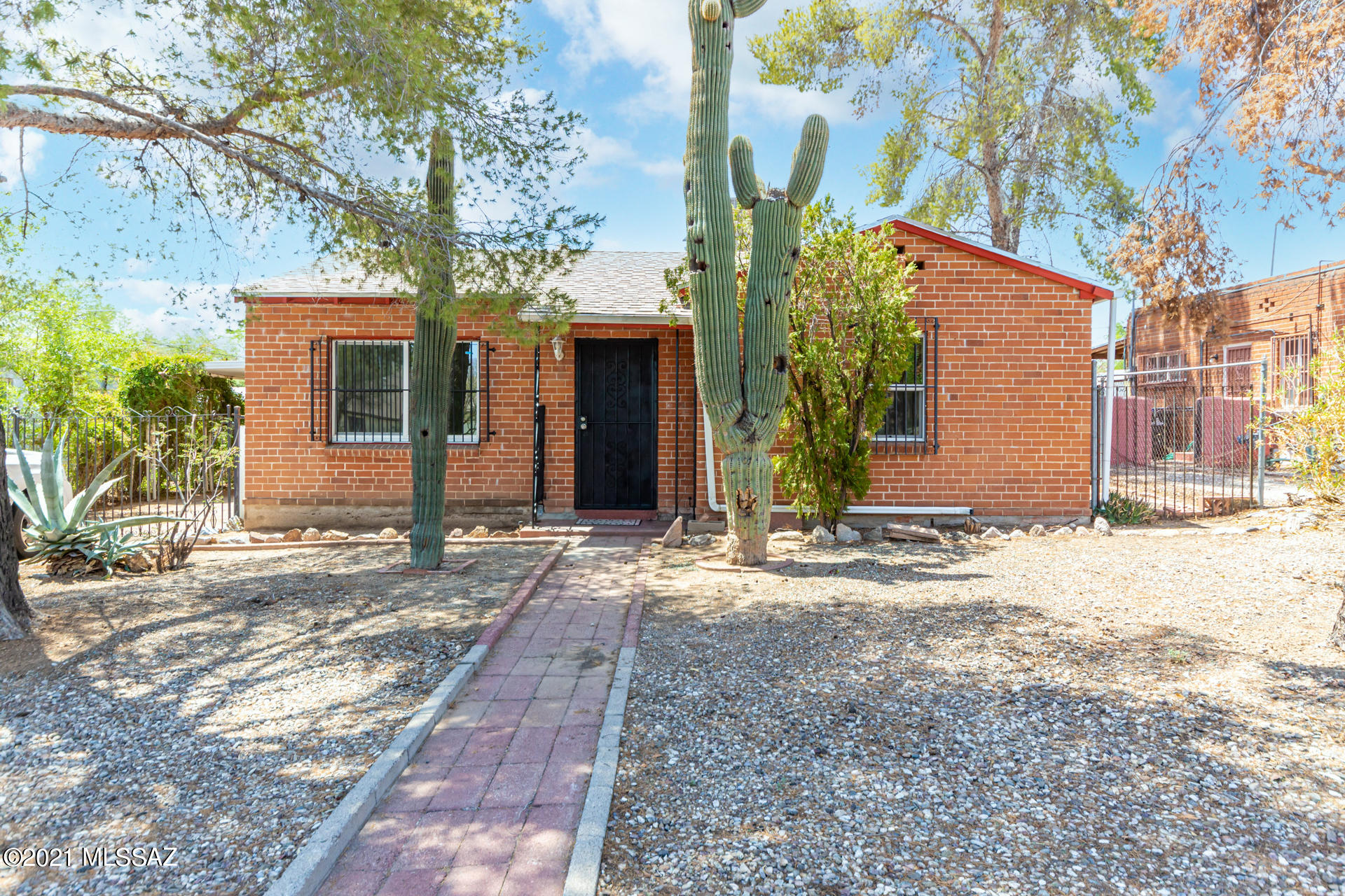 Beautifully Remodeled 1940's bungalow minutes away from U of A, downtown, bike path and public transportation.  Trending new palette, new wood look tile floors, & spacious eat-in kitchen. Plenty of freshly painted cabinets w/hardware, essential appliances, neutral tile floor, several open top cabinets, & stylish new counters w/an under-mount sink. Main bedroom boasts 2 closets, plush carpet, brick accent wall, patio access, & a private updated ensuite w/designer touches.  New engineered wood floors in 2nd bedroom, ample closets, & pristine new baths. Fantastic AZ room w/endless possibilities. Huge yard for all your toys & room for a pool! BRAND NEW AC installed 2021! Take a tour today & stop renting!