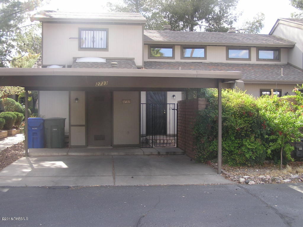 SWEET end townhome unit with carport, small private yard and PLENTY of storage. The soaring ceilings provide loads of natural light and openness to this home. Master Bedroom, kitchen Living area and bathroom on ground floor, the second bedroom is a LARGE loft style room upstairs. Two car covered carport great location across from the pool!  MUST SEE.
