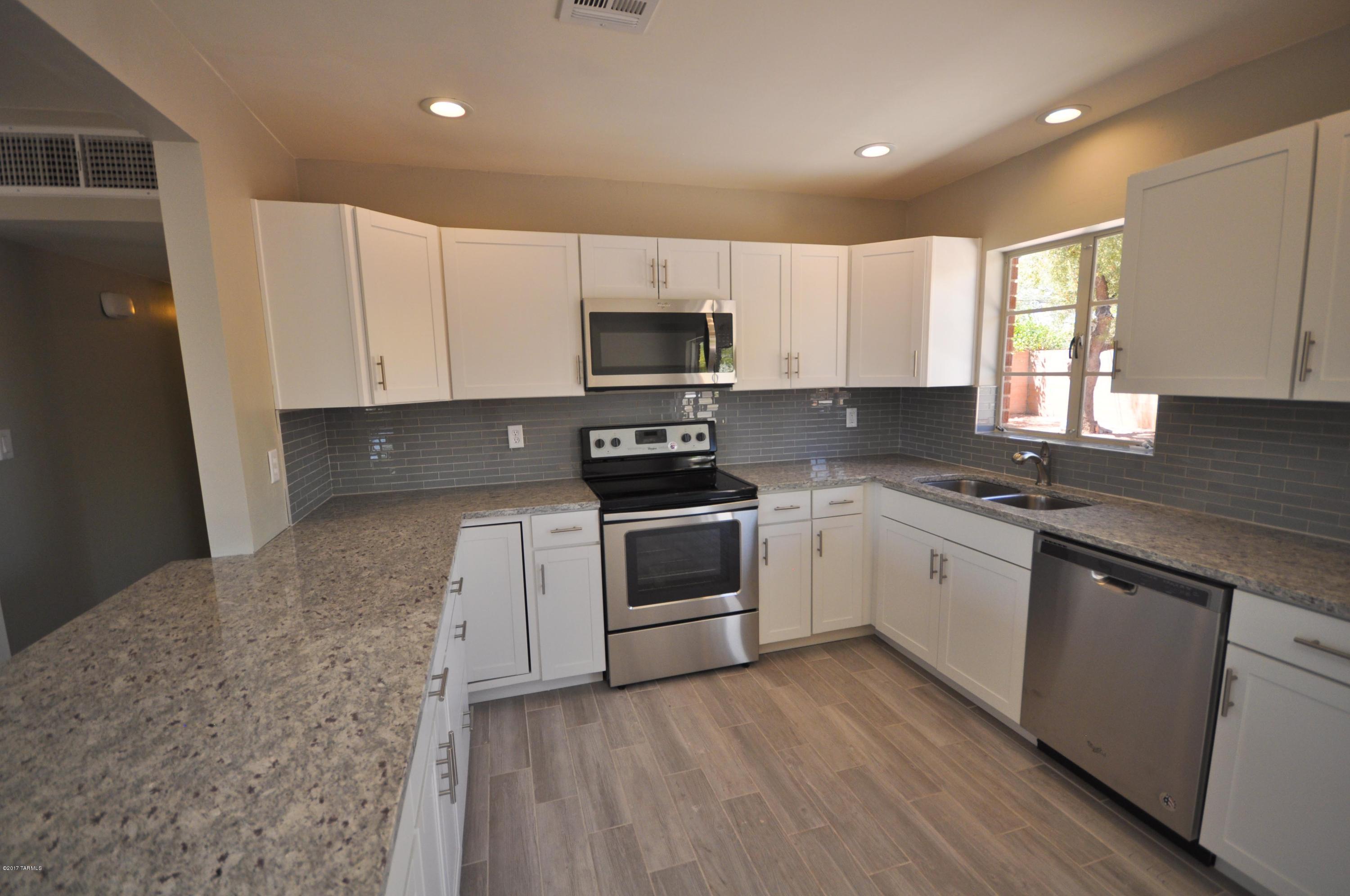 Freshly remodeled move in ready 4 bedroom red brick home just minutes to the university and medical center. Upgrades include new white shaker kitchen cabinets, granite countertops, new appliances, wood plank tiles throughout common areas, plush carpet in bedrooms, new interior two tone paint, and freshly coated roof. Sellers hold AZ real estate license