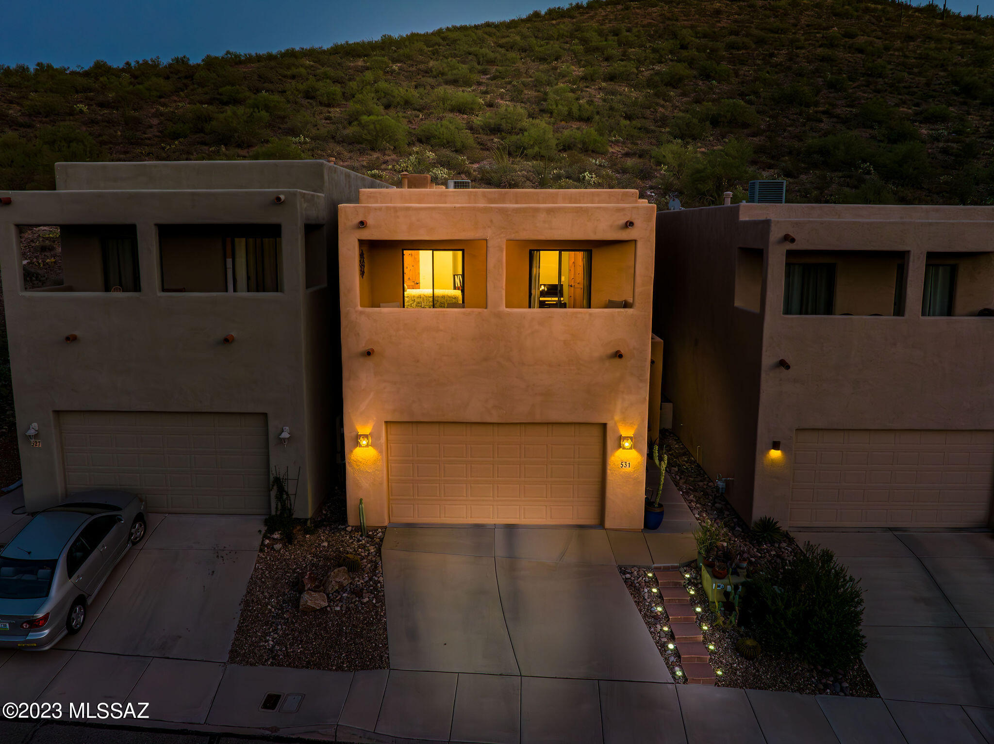 Highly sought after Community at the base of Sentinel Peak; 'A' Mountain. This home offers the perfect blend of urban convenience with a tranquil feel! No homes behind you-only a gorgeous and private mountain view!
This home has been meticulously updated from the kitchen to the bathrooms and features custom details throughout beginning with handcrafted hardwood stair treads accented with a mosaic tile rise; knotty Alder doors; newer tiled flooring, paint, decorative lighting, ceiling fans and newer LED recessed lighting (most are on dimmers). 
Enjoy your family and friends at the kitchen island opening to the living and dining rooms. Designer look with a beautiful white quartz countertop on the island with an extra deep single bowl stainless steel sink, Alder cabinetry with 42'' upper cabinets and gray quartz on the back countertop with a decorative tiled backsplash. 
Living room delivers a modern updated gas fireplace with tile surround as well as an 8ft sliding glass door leading to the professionally designed yard that features a BBQ stub for outdoor kitchen, Saltillo tiled patio with ceiling fan, extensive flagstone, decorative rock and desert plantings. Both living room and patio are wired for surround sound.
The spacious owner's suite offers a cozy gas fireplace, ceiling fan, recessed lighting, and a private balcony with a mountain view. Owners bathroom will not disappoint! Tons of natural light; oversized walk-in shower has two showerheads and decorative tile from floor to ceiling; executive height double vanity with stunning quartz countertop; designer lighting around custom mirror; updated faucets and a dream closet designed by Classy Closets with Alder cabinetry, 10 drawers and adjustable custom shelving.  
Upstairs you'll find a spacious loft area (currently used as an office) plus two additional bedrooms with walk-in closets. These rooms lead to the front balcony boasting panoramic views of multiple mountain ranges, sunsets and city lights! The hall bathroom has been updated featuring an executive height vanity, undermount sink, high end quartz countertop, decorative mirror, lighting, faucets and glass tile surround in shower.
Home has 2 programmable thermostats allowing for comfortable living spaces; central vacuum; skylights throughout; newer smoke alarms and dual flush toilets. Spacious guest powder bath offers decorative mirror and lighting. The entryway allows for a convenient 'drop' zone with the walk-in closet and abundance of hidden storage space...Need extra storage? The garage offers ample room for the installation of cabinetry or upper storage if needed, thanks to its generous ceiling height and spacious floor area.
Located within 1-2 miles of Downtown and the Mercado District, there is something for everyone from dining, shopping, farmers market...right into a vibrant night life!