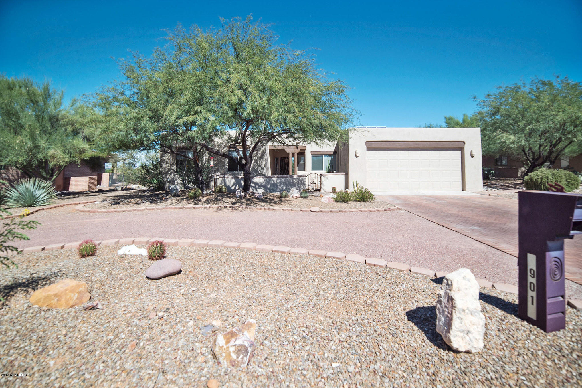 What a find! A solar powered home in Madera Reserve with terrific Santa Fe curb appeal. You’ll enter into an elegant living room with soaring ceilings, peeled log posts, angled architecture, and wood casement French doors offering desert views. The beautiful travertine tile rolls up surrounding a cozy corner gas log fireplace. The hub of this splendid floor plan is the family room illuminated by an array of view windows and the family room opens to the center polygon shaped kitchen with perimeter light soffit suspended by peeled log posts. Rich wood cabinetry and a granite backsplash accent the gleaming stainless appliances. The functional under counter stainless prep sinks are surrounded by solid granite counters displaying opulent multi-blush tones. Like a beautiful mural, the dining area picture window brings in desert views for a relaxing eat-in experience. The exquisite features continue into your roomy master sanctuary with its executive height bathroom vanities, corner soaking tub and walk-in shower. This home has 4 bedrooms - one has a murphy bed and one is currently being used as an office. Incredible outdoor living - select from several different sitting areas on the back patio to enjoy the outdoors. The extended brick patios flow out to colorful greenery, indigenous rock accents with endless views of the desert landscape or enjoy the magical colors at sunset or star gazing at night. A real find, indeed!