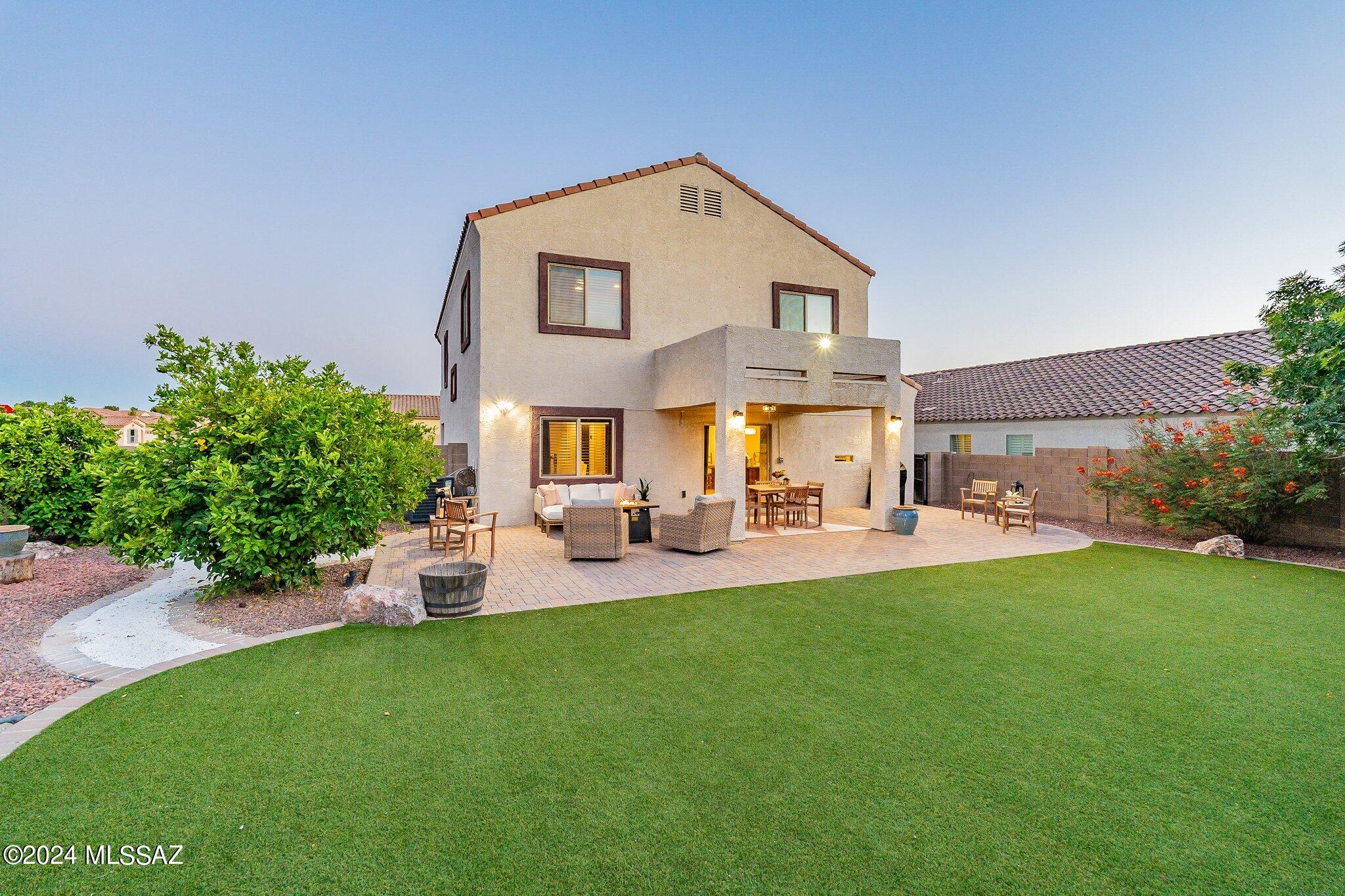 Gorgeous, contemporary 4BD home in exclusive gated community. Enjoy your backyard oasis w/ only 1 side neighbor, mature fruit trees, flowering bushes, turf grass, & large extended patio area.The neighborhood pool & park are just steps away across the street. 
A charming front porch welcomes you  into a spacious open family room, kitchen, a large dining room area! Maple cabinets, kitchen island, breakfast bar, stnless steel appl, & two pantries. The 1st floor also features a front den & bathroom that could easily be converted into a 5th BD. Upstairs, you'll find a freshly painted, huge loft & a spacious primary bedroom retreat w/ a luxurious garden tub, dual sinks, and a walk-in closet. This secluded neighborhood is conveniently located near golf, shopping, restaurants, bike path & I-10! This home is on a HUGE lot and HOA has approved the wall to be moved up towards the front yard to add even more space to your backyard. New approval would need to be submitted by new owners. 
No rear neighbors and no neighbors on one of your sides. Very private lot! 
Washer, dryer and bedroom curtains do not convey.