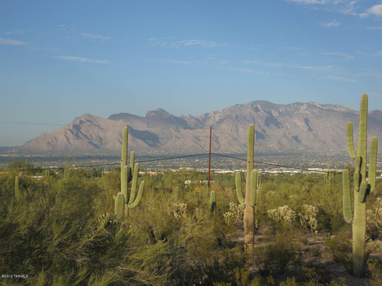 NOW PRICED TO SELL!!!!...RARE 13.77 ACRE RECTANGULAR PARCEL WITHIN MINUTES OF DOWNTOWN TUCSON AND U/A! Gently sloping to the east offers fantastic views across Tucson valley to the Catalina Mtns. Suburban Ranch zoning allows for 3.31 ac parcels. Property could be subdivided into 4 parcels. Build your DREAM HOME and sell other parcel(s) to offset expenses!! Partially standing stone residence had electrical, well water. New well would be required, or, Tucson Water Co. runs along Ironwood Hill. This is an excellent opportunity for custom builder, horse owner,  or those seeking peaceful desert solitude among hundreds of native cacti w/gorgeous city & mountain views. Horse property with great trails from wash across east end of property. Call today to walk the corners of this special property!