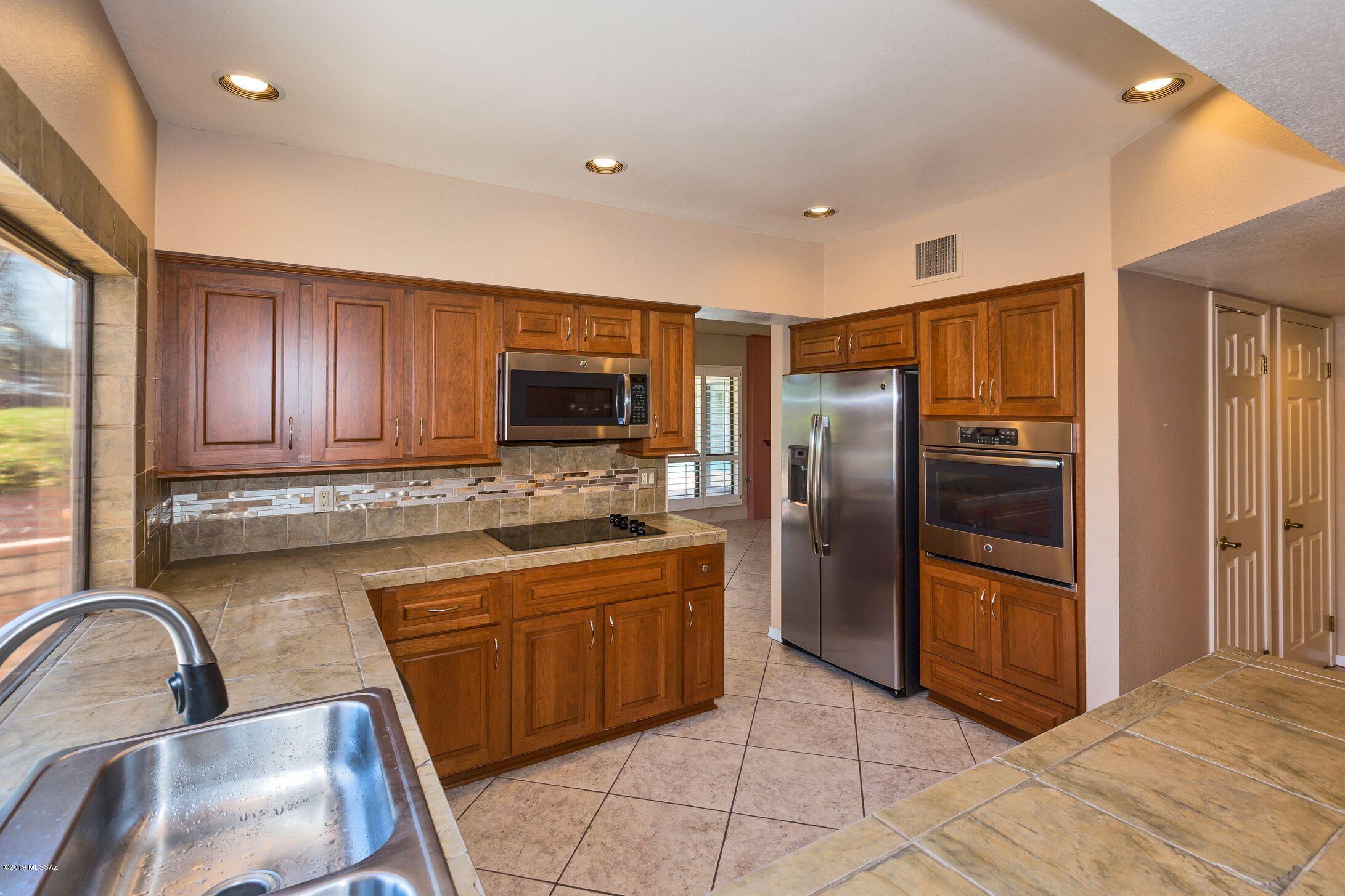 Charming 3 bedroom/2 bath Almeda with beautiful mountain views from kitchen, dining area, breakfast nook, great room, both guest bedrooms and bonus room! Kitchen boasts stainless steel appliances, tile counters and backsplash, under cabinet lighting and gorgeous soft close cabinetry. As you enter the master bath you are immediately awed by the stunning tile shower, upgraded dual sink vanity and storage. Spacious master bedroom with upgraded carpet/padding has additional bonus room that can be your new seating area or office! Updated guest bathroom has custom vanity and tiled shower/tub. Sparkling pool with multiple seating areas gives you a premium view of the Catalina Mountains! Home located a short walk or golf cart ride away from SaddleBrooke amenities, restaurants and golf courses.