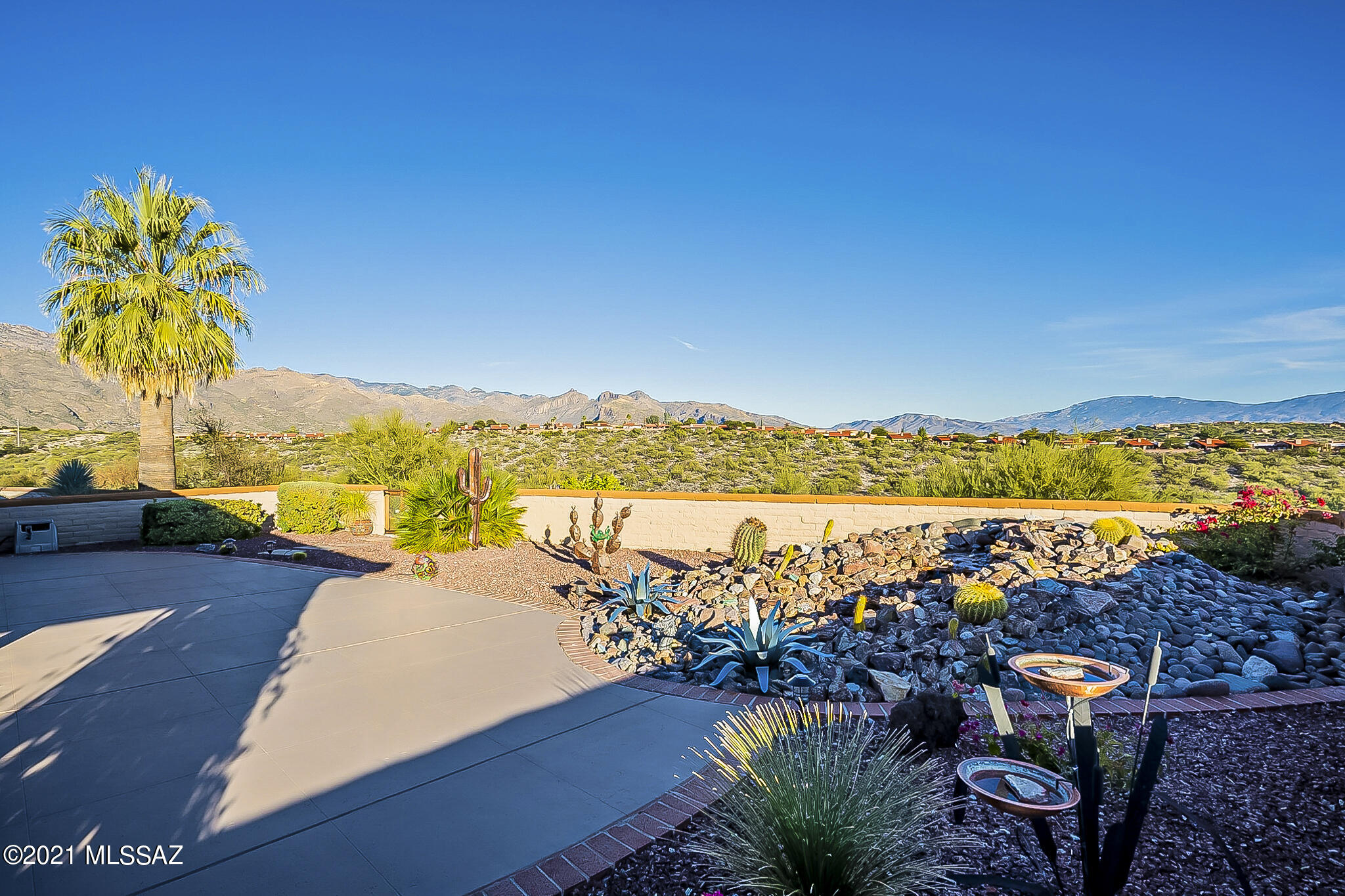 Ridge Top Property w/ Breathtaking views of Catalina & Rincon Mountains from back of home PLUS Tucson Mountain Views from front, Kitchen, Breakfast nook & Guest Bedroom patio!  Being sold fully furnished/turnkey single level townhome, The charming paver courtyard takes you to the Wrap around patio, large back patio w/ rock waterfall/fountain enjoy the Panoramic Views.  Interior is warm and cozy 2 spacious bedrooms plus den, fully equipped w/ upgraded kitchen cabinetry, ample storage space, quartz counter tops, & breakfast nook.  Separate custom dining set next to bay window. Beautiful Art work adorns the living room w/ corner fireplace, Skylights throughout, Enjoy more views from the spacious Primary Suite is extended bonus room to enjoy the Views! Price includes all furnishings & Decor