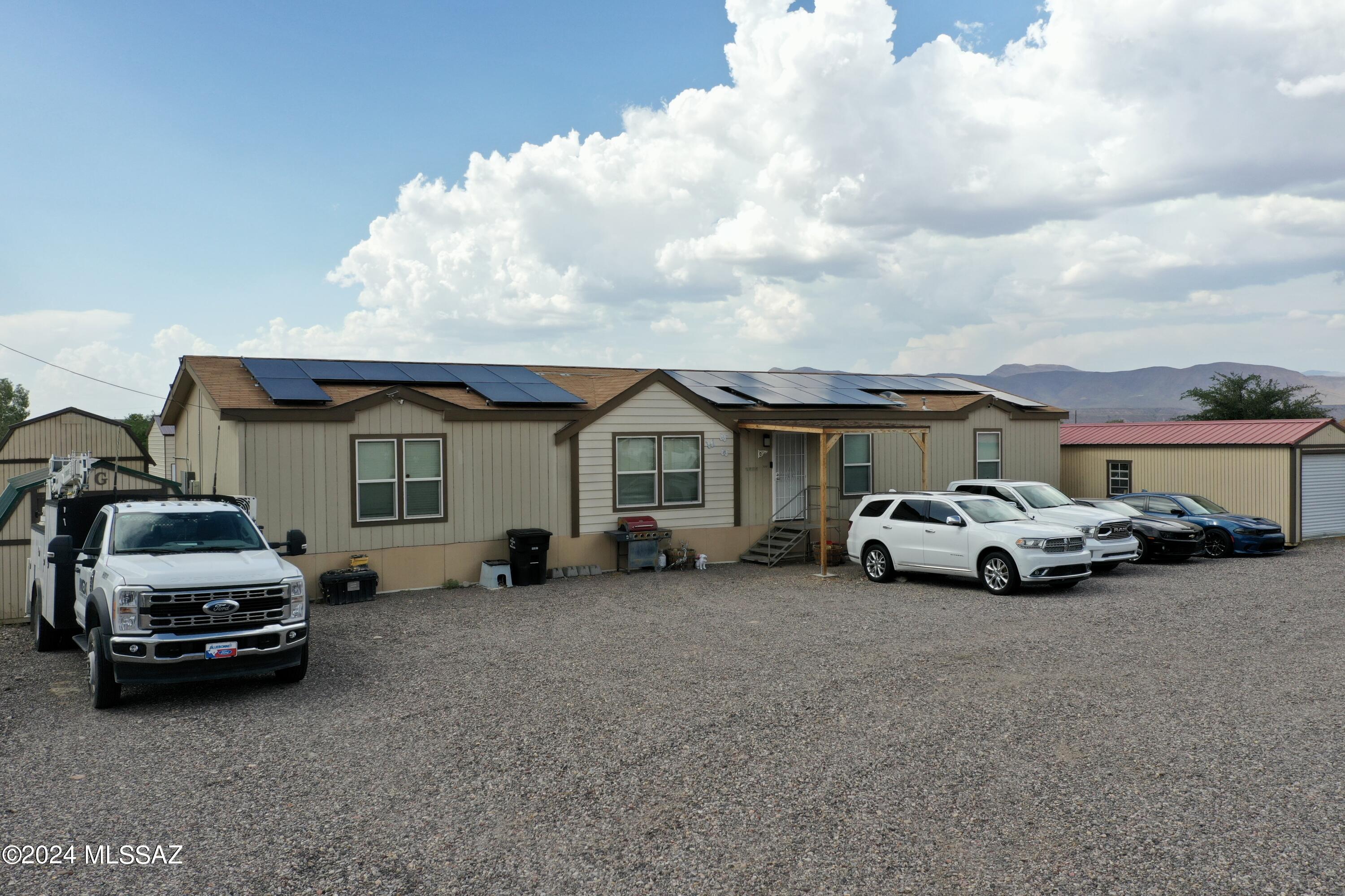 This amazing home features a split floor plan with two spacious master bedrooms. In addition the other two bedrooms are large in size with a shared bathroom. The kitchen has plenty of storage and space with an open dining space that overlooks the living room. Low utility bills with the help of solar panels! Multiple storage sheds are on this one acre lot with the bonus of a 30x40 shop with three 8 ft doors and 12 ft ceilings! Call today to schedule a showing!