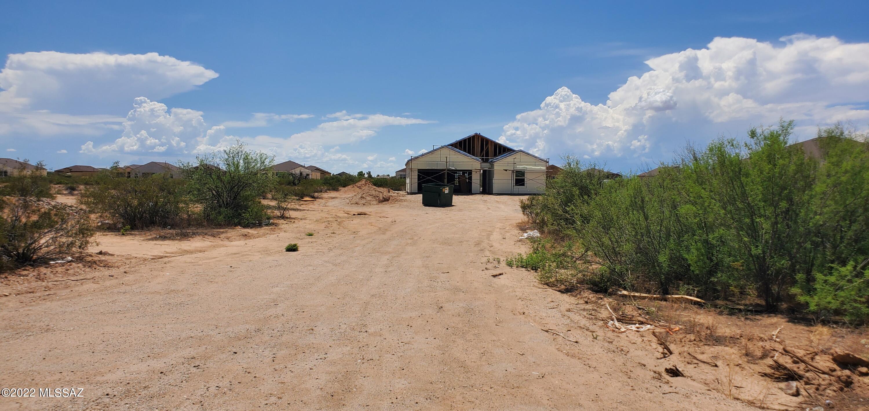 Open great room floor plan with many upgrades including shaker style cabinets, wood look tile flooring, upgraded carpet, granite kitchen countertops, quartz countertops in baths, stainless electric range, dishwasher, microwave and much more all set back from the road on approximately one acre.