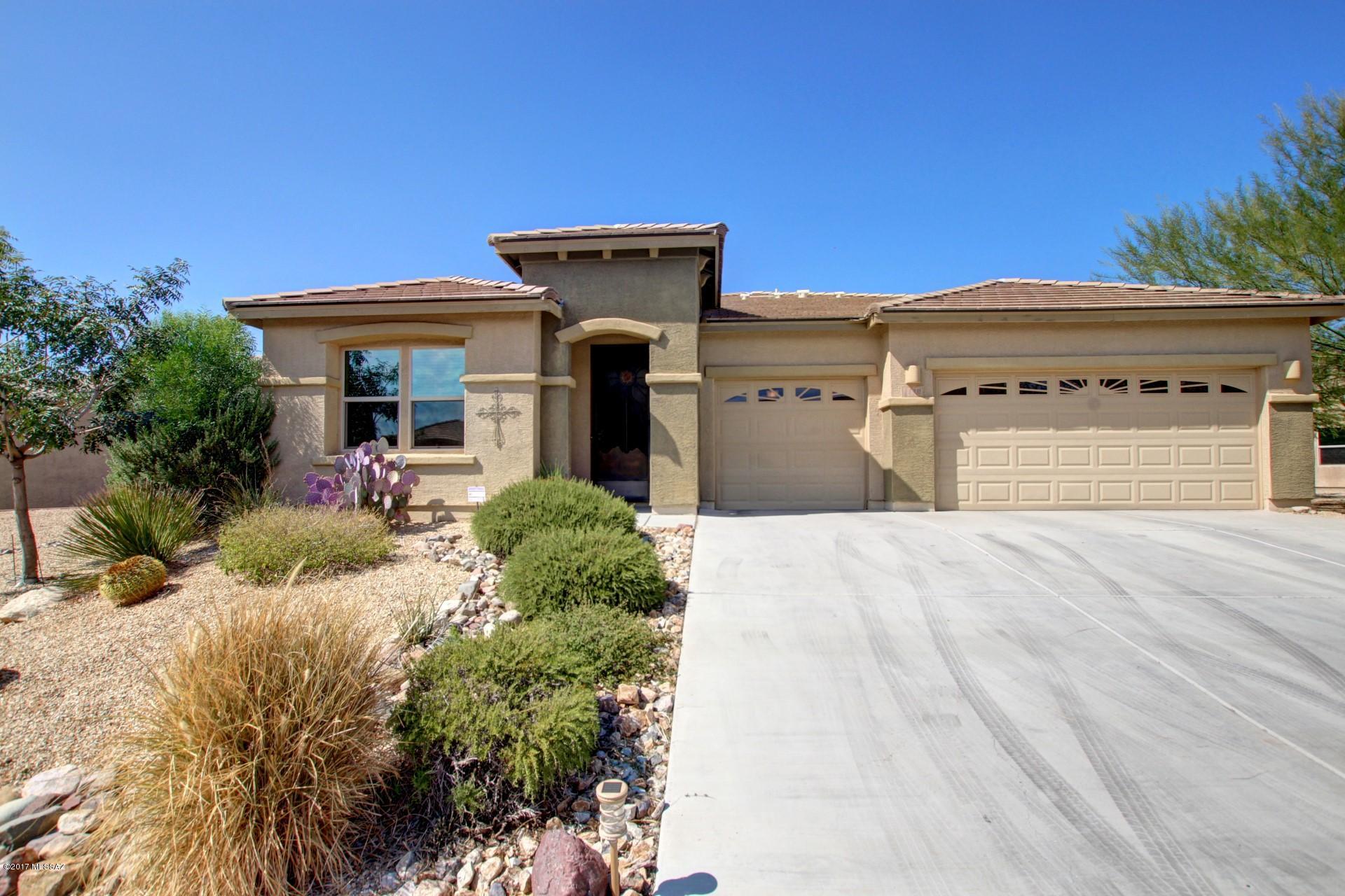 Look no further! Beautiful single story, 4 bedrooms with office, 3 baths, 3 Car Garage in Madera Highlands. Elegant Chef's Kitchen boasts Granite Counter and Glass Tile backsplash, Cabinets have pull outs, extra pantry and Center Island off the Living Room; is perfect for entertaining.  A formal dining room, Ceiling Fans throughout, Custom Tile Floors.  Custom Security Screen Entry, Huge Laundry Room with Washer/Dryer and Owned Roof Solar are a few of many amenities.  Large master Suite w/ French Door to Patio, Master Bath w/ Custom Backsplash surround, soaking tub, separate shower and large walk-in closet. The Arizona Room leads to the private landscaped garden of fruit trees (Tangerine, Ruby Red Grapefruit, Nectarine & Apple), Grape Vines & Raised Beds. See This Stunning Property Today!
