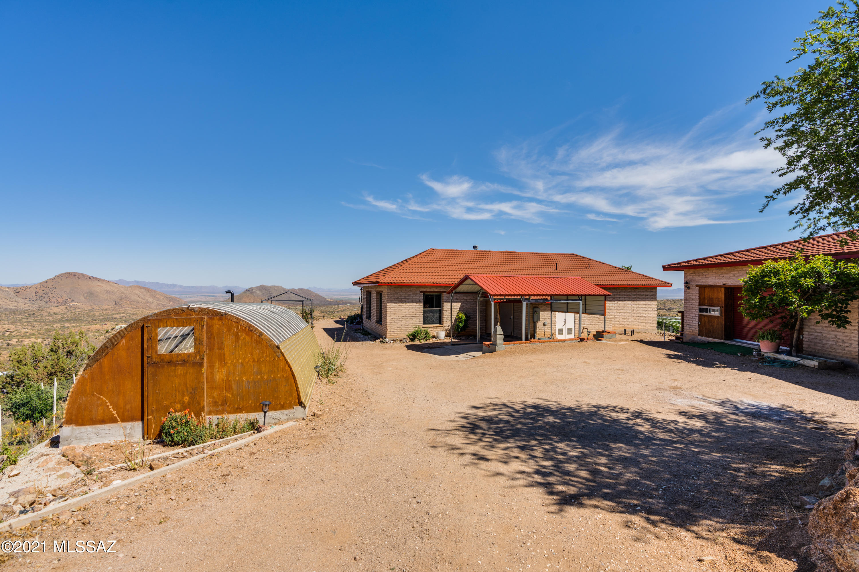 Island in the desert sky! Immerse yourself in breathtaking views every direction at your hilltop custom home on 16 acres. Thoughtfully designed adobe home boasting  16-24'' thick walls, Decra roof system, cross ventilation, solar floor heating,  & a private walk in safe.  Innovative layout with split master suite & large guest rooms, generously sized laundry room & hall bath w/closet , an impressive great room, large kitchen w/endless counters & cabinets, beautiful custom tile work & murals add to its special charm. Guest house/artists studio is an open floorplan with kitchenette, bathroom & private patio. 2 car garage/workshop & new carport. The property is peppered with seating areas, lookouts, rose gardens, two small orchards, & enclosed vegetable garden. Come see & Fall in love today!