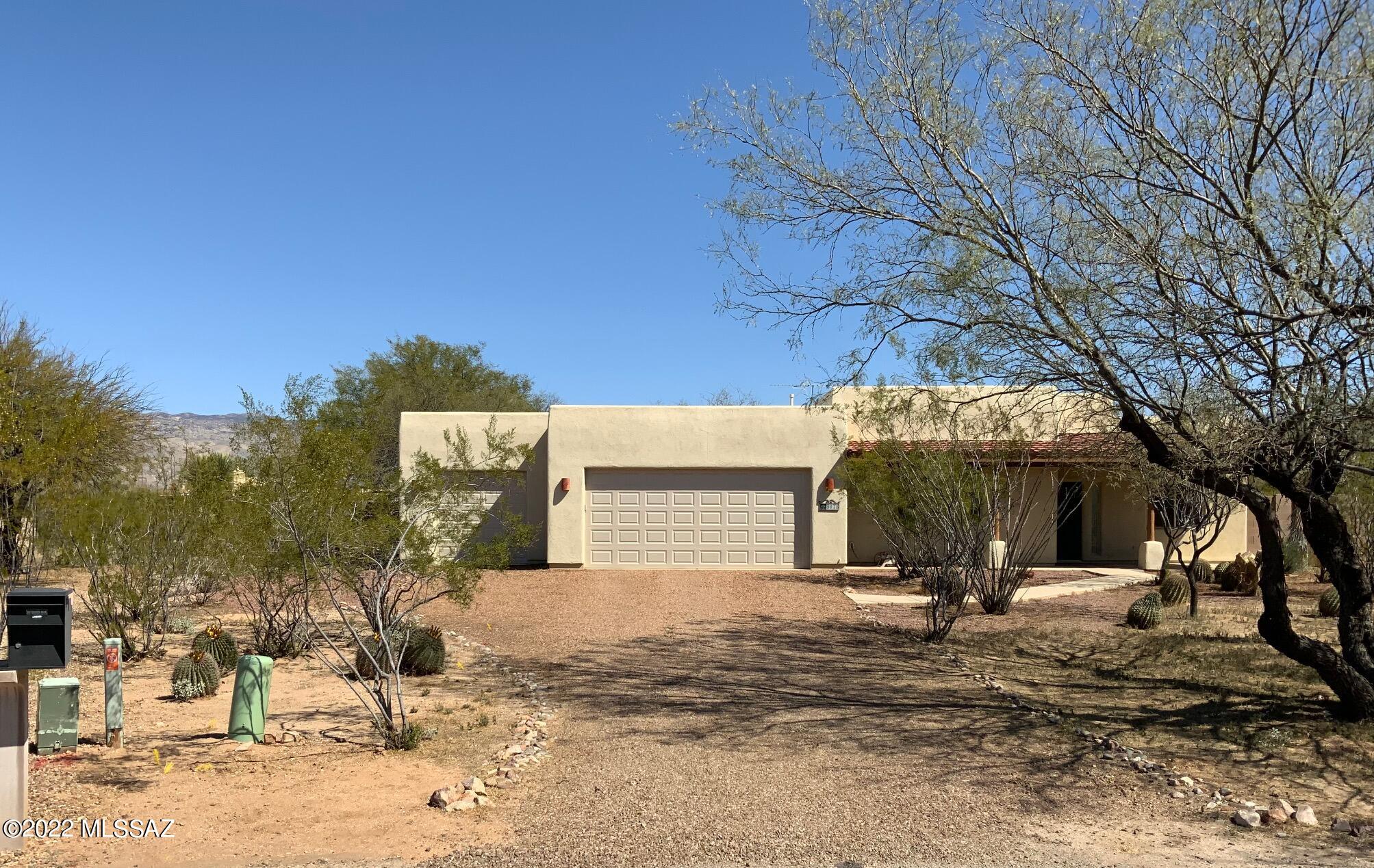 Custom Santa Fe on .93 ac in Antler Crest Estates, an established Vail community committed to preserving the natural desert landscape. Amazing Rincon Mtns, sunrise and sunset views! Fully tiled 3 Bdrms/2 Baths plus an air conditioned Office & 1/2 Bath in 3rd bay of garage!  Owned 3.5 kw solar electric system. Covered front porch. Extended covered patio with remote controlled screens can be accessed from 4 doors. Gas stub for BBQ.   Bright, spacious living room, high ceilings, & gas fireplace. Ceiling fans. Huge kitchen, island, pass-thru tiled bar to dining area, pantry, rollouts, & breakfast nook. Includes newer  refrig & washer. Dryer. Roof coated 2018. Double and single gates to backyard. Whole house water filtration. Sentricon in ground. On Septic. One owner.  Low HOA. Vail Schools.
