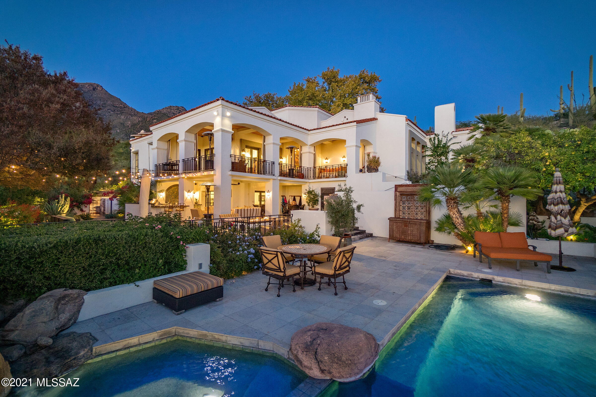 This sensitive and ambitious restoration by renowned California designer Michael Roy, retains the essence of the original architecture, whilst creating a renewed vision of amenities and services an owner would expect from a home of this caliber. The fit out and quality of finish is incomparable, proportioned with elegant architectural features and large steel casement windows providing views over the established grounds. Situated on a commanding view lot overlooking the greens of the 1st fairway, this adaptive remodel demanded privacy while preserving views that open out to far reaching vistas of the adjacent Catalina mountains, stretching out over the expansive city lights beyond. The home's interiors feature the highest quality materials, adorned with reclaimed solid oak wood floors, juxtaposed against an inlay of Spanish deco tile. Interiors are complemented by a cohesive blend of custom cabinetry styles and finishes throughout, which include Whitney recessed oak, contrasted against black espresso, with open pore wood treatments, fitted with a combination of quartz and granite surfaces. 

As one travels between the individual spaces, dramatic landscapes unfold, allowing for an abundance of natural light from every room. Transparent facades and French doors fuse indoor and outdoor living environments, used to derive a sense of spatial richness. The estate integrates cutting-edge technology that uses an iPad interface automation for sound, with security and camera monitoring capabilities.

The design facilitates 4 bedrooms and 5 baths with a main level owner's suite, luxurious bath, stone clad walk in shower and private garden retreat. One additional en-suite bedroom is housed on the main level, with all supplementary en-suite bedrooms discreetly sequestered on the lower level physically connecting the interior to a generously shaded veranda, creating a gradual transition from the materially warm interior spaces to outdoor living and entertainment.