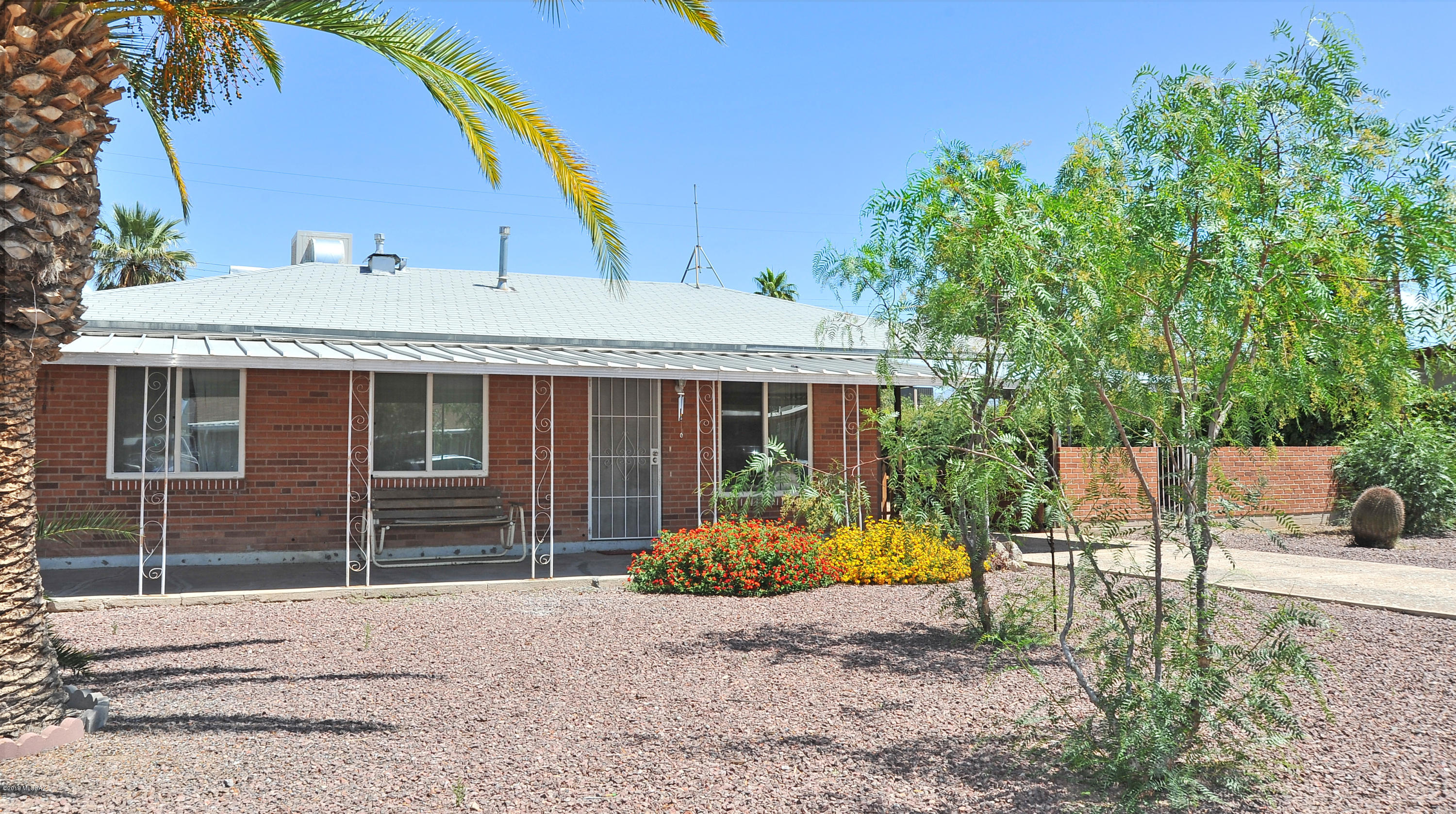 Cute cute bungalow in Central Tucson!  Great yard with mature landscaping, front & back porches, carport, and large backyard with alley access! There's plenty of room for a pool too.  Lovely fruit trees in the back provide nice shade-3 orange and a fig. Updated kitchen, bath & flooring so the work is done. Newer gas water heater. Dual pane vinyl windows installed for your comfort!  Central A/C as well as evap cooling - your choice!  Welcome Home!