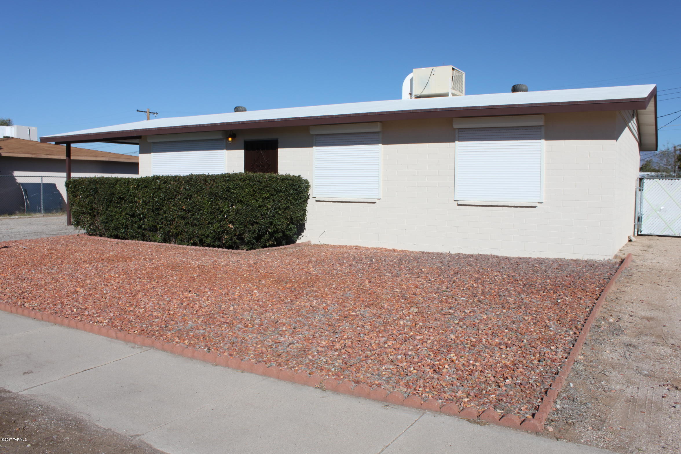 Updated and move-in ready! This home has been well cared for and been in the same family since it was built. Kitchen has newer appliances, granite counters just installed, plus plenty of cabinet space. Updated bathrooms, tile floors in kitchen/bath/living  room/hall and wood laminate in bedrooms. Dual pane windows throughout, plus rolling shutters on all windows. Nice workshop space, huge backyard with 3 double gates for access. 2 side gates and 1 alley. Covered patio, and newly renovated laundry room. Located in a well kept neighborhood that is convenient to shopping, public transportation and other amenities. Evaporative cooler conveys as-is.