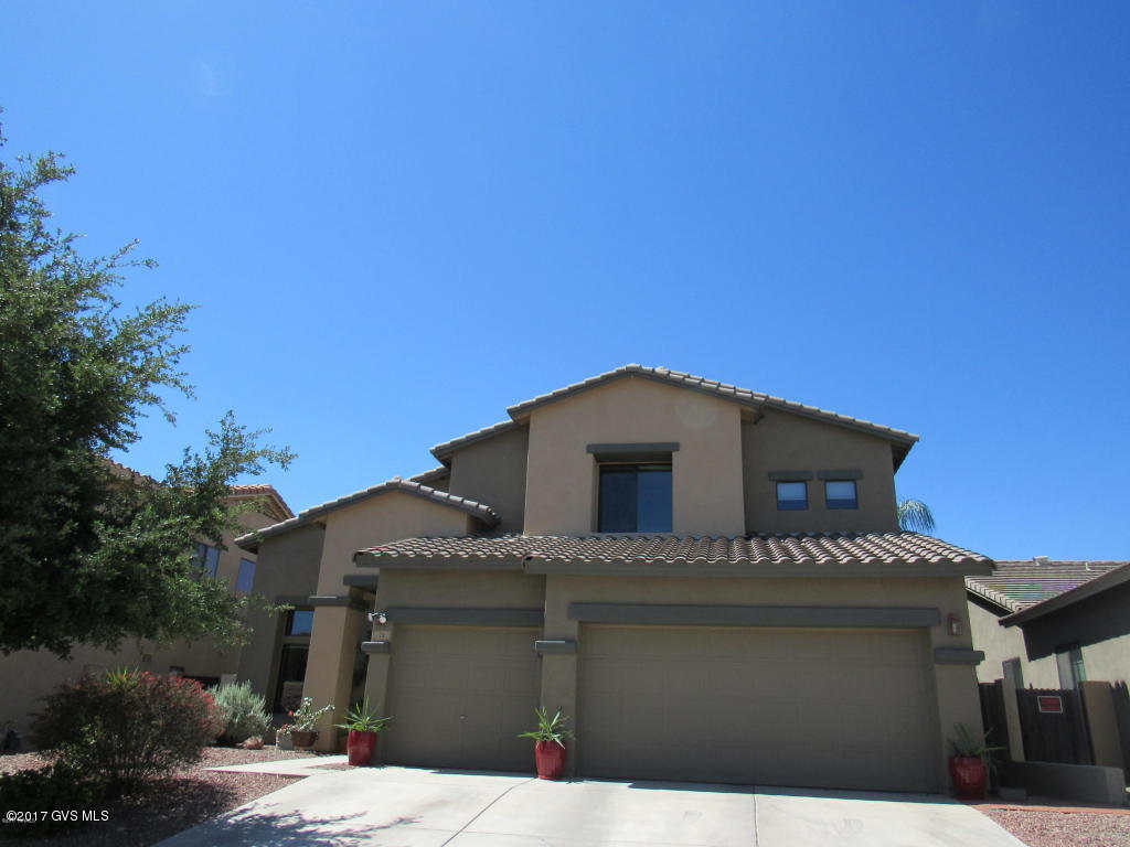 Embrace all this beautiful home has to offer! Located just doors away from the community pool, gym, parks and water park. Spacious 2799 sq ft, 3 car garage, 4BD/2.5BA home w/ no rear neighbors. Upgraded tile floors throughout the downstairs, adds to the dramatic look of this home. Gorgeous family room w/ fireplace, flows into the kitchen w/ newer SS appliances and gas range. The downstairs master suite w/ french doors has a large walk in closet, en suite master bath w/ dual sink vanity, soaking tub and separate shower. Upstairs has a loft for additional living space, and 3 spacious bedrooms. Hunter Douglas window coverings. Generous landscaped backyard features a low maintenance faux lawn, outdoor kitchen, stone fire pit, planting bed, fruit trees and covered patio. AWARD-WINNING SCHOOLS!