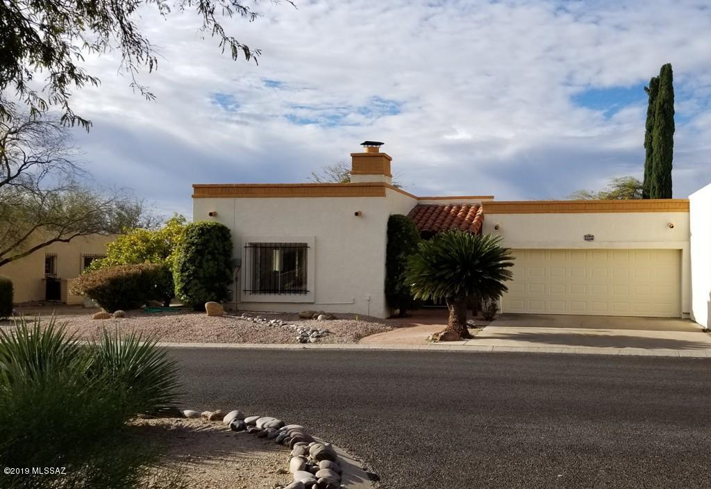 Awesome setting! End unit TH sitting on one of the largest lots in Desert Hills 3 East. Common area on the east side provides nice morning sunshine in the kitchen eating nook.  Arched openings and passage ways, a gas log beehive fireplace in the L shaped living/dining rooms and saltillo tile in the wet areas all lend to the charming southwest feel of this home.  Wait til you see the size of the master BR and 2d BR with a Murphy bed in the rear of the house that walks out to a deep covered porch and an open patio all bordering a huge arroyo below. You can see San Cayateno from here! This home is being offered fully furnished as you see it including pots, pans, linens, etc. !   2011 Heatpump . Newer fridge, DW & MW. AND 2.5 car garage! Turn key opportunity priced for your updates.