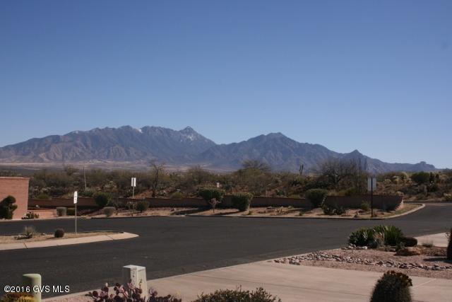 This view could be yours if you lived in this beautiful townhome in Desert Hills l. This is a highly desireable end unit with a patio that has two fruit trees and borders the Arid Garden on the South. Front patio presents a great view of the mountains. Upgraded tile floors in hall, kitchen and baths. Newer cupboard facings with all newer hardware. Beautifully furnished and furnishings are included in this price which makes this unit ready for an easy move in. Also included is a large stack washer/dryer in a separate closet. Sun Screens on all appropriate windows. Large extra storage closets off back patio and carport. New paint throughout interior. You don't want to miss this one!