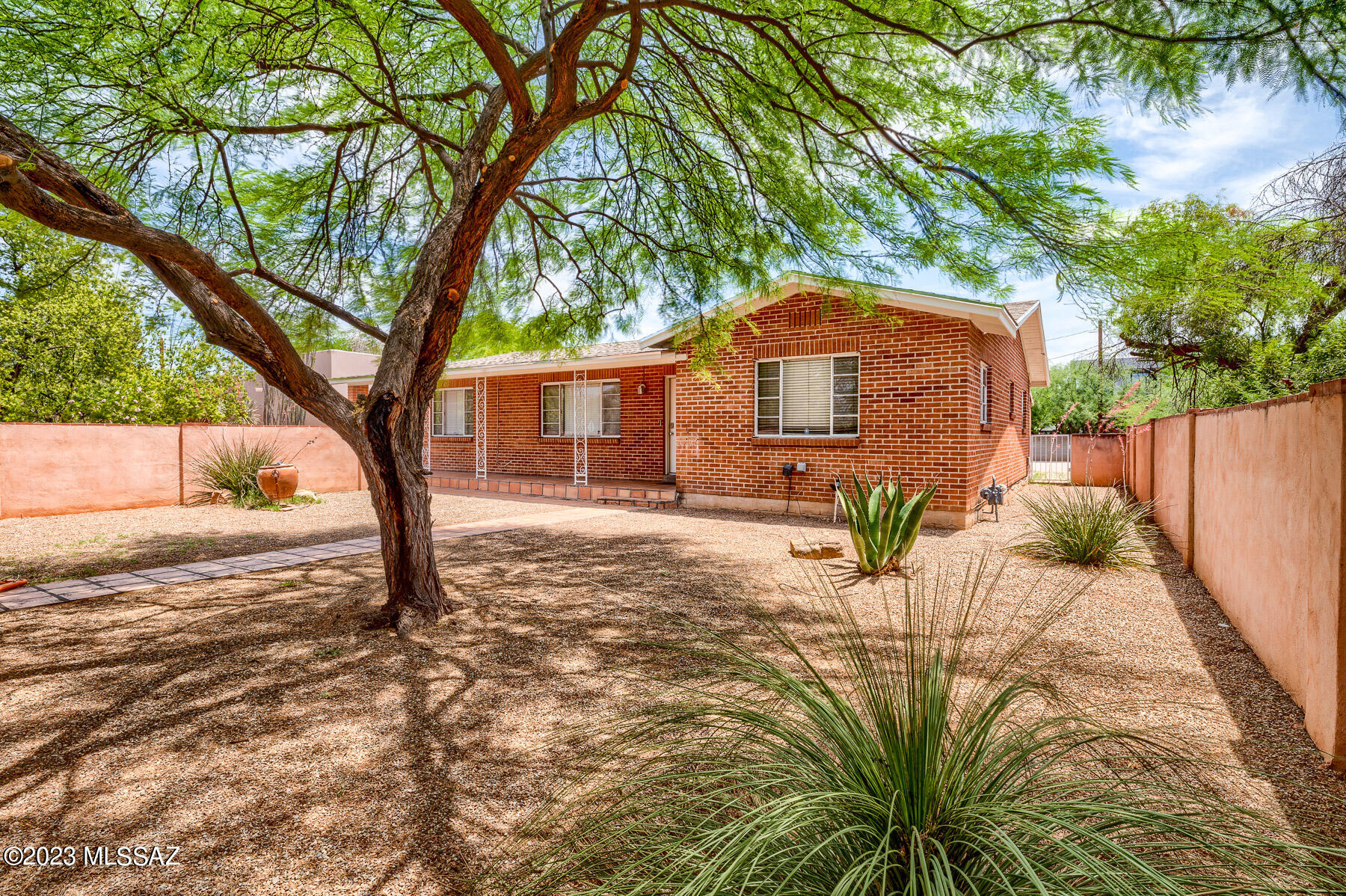 Welcome to this beautiful mid 50's ranch style home. This home offers a great location @ midtown. Home boasts 4 bedrooms with 2 bath, large  laundry-room and lots of storage inside. Kitchen offers dining area and tons of cabinets. This beautiful home has a recently replaced roof with 3year warranty. Trim has been recently painted. The home is ready for its new owners. Very close proximity to the University of Az, shopping and other wonderful amenities. The home has a huge back yard with detached garage/shop/carport currently with newly installed wrought Iron gates. The beautiful front yard offers a massive mesquite tree that offers tons of shade along with the large covered front patio. This wonderful home has a ton to offer. Be sure not to be the one who missed out. Come see it today.