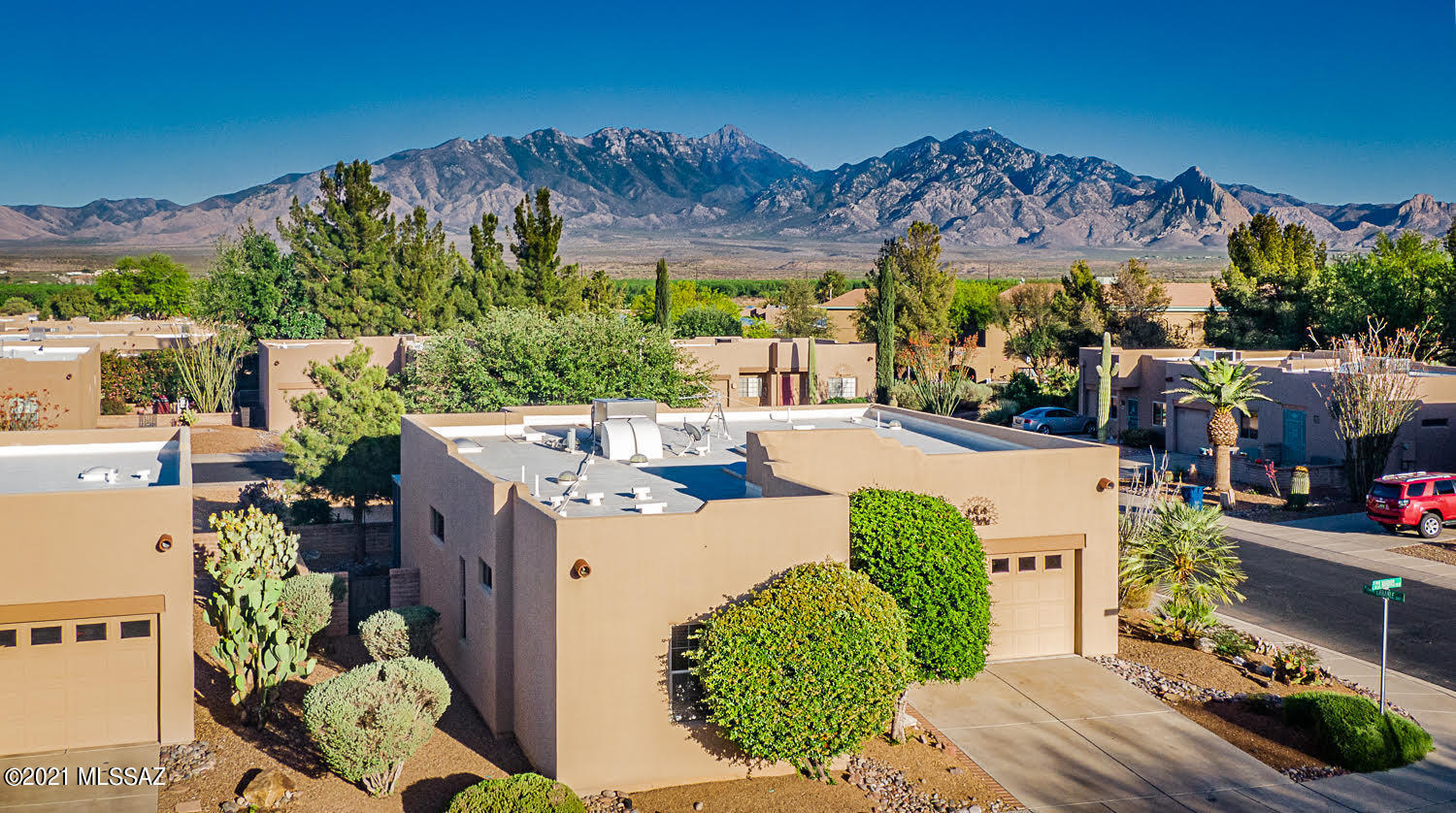 Fantastic free-standing home on a peaceful corner lot in the Springs! Enjoy Santa Rita views from the backyard. Popular Hacienda floorplan features an open concept living/dining area w/ split BR's. Newer heat pump, carpet in living area & primary BR. Jetted walk-in tub in guest bath. Beautiful wood valences on windows. Pretty tile on breakfast bar. Relaxing AZ room to enjoy the tranquil backyard & mountain views. Warm and bright throughout with multiple skylights & solar tubes. 2-car garage with epoxy coated floor, newer garage door opener & water softener. Roof recoated & exterior trim painted w/in last 2 years . Termite contract will transfer. Very close proximity to the fabulous Springs GV Rec center. The Springs also offers a 25 acre park, and 1 mile walking trail.