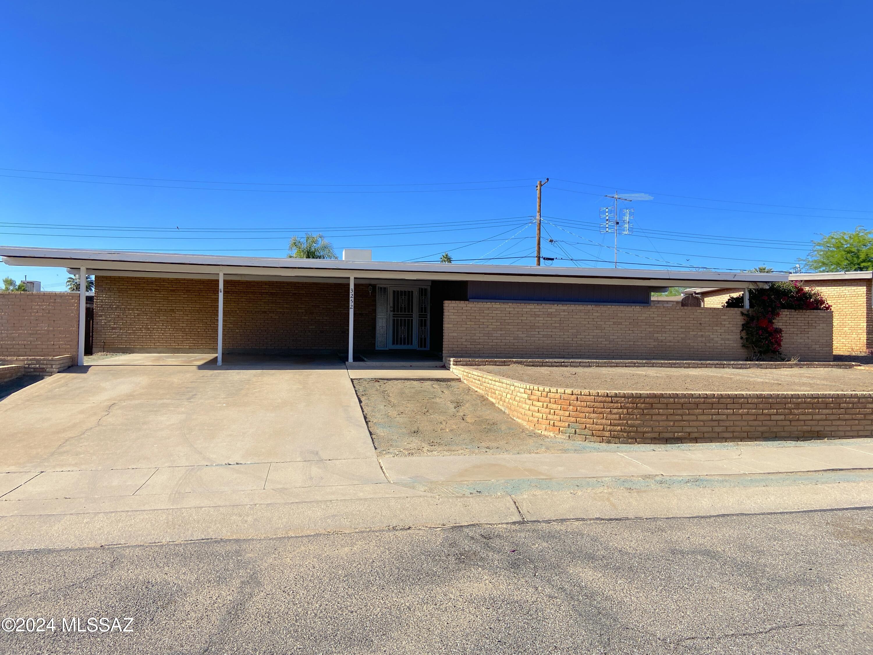 Welcome home to this Orange Grove Valley ranch style house. 3 bedrooms, 2.5 bathrooms and 1,814+ sq ft. One owner home, built in 1961. Kitchen with family room and access to the backyard from the slider.  Living room and dining room with access to the back yard.  Primary bedroom with private 3/4 bathroom.  Powder room off the living room for guests.  Carport off the front fits 2 cars.  Access to the alley from the backyard.  Yes, it needs some remodeling.  However, this home is solid and has great bones.  Bring your ideas and imagination and make this home your own. Quick access to shopping, I-10, and all that NW Tucson has to offer. Come see for yourself!
