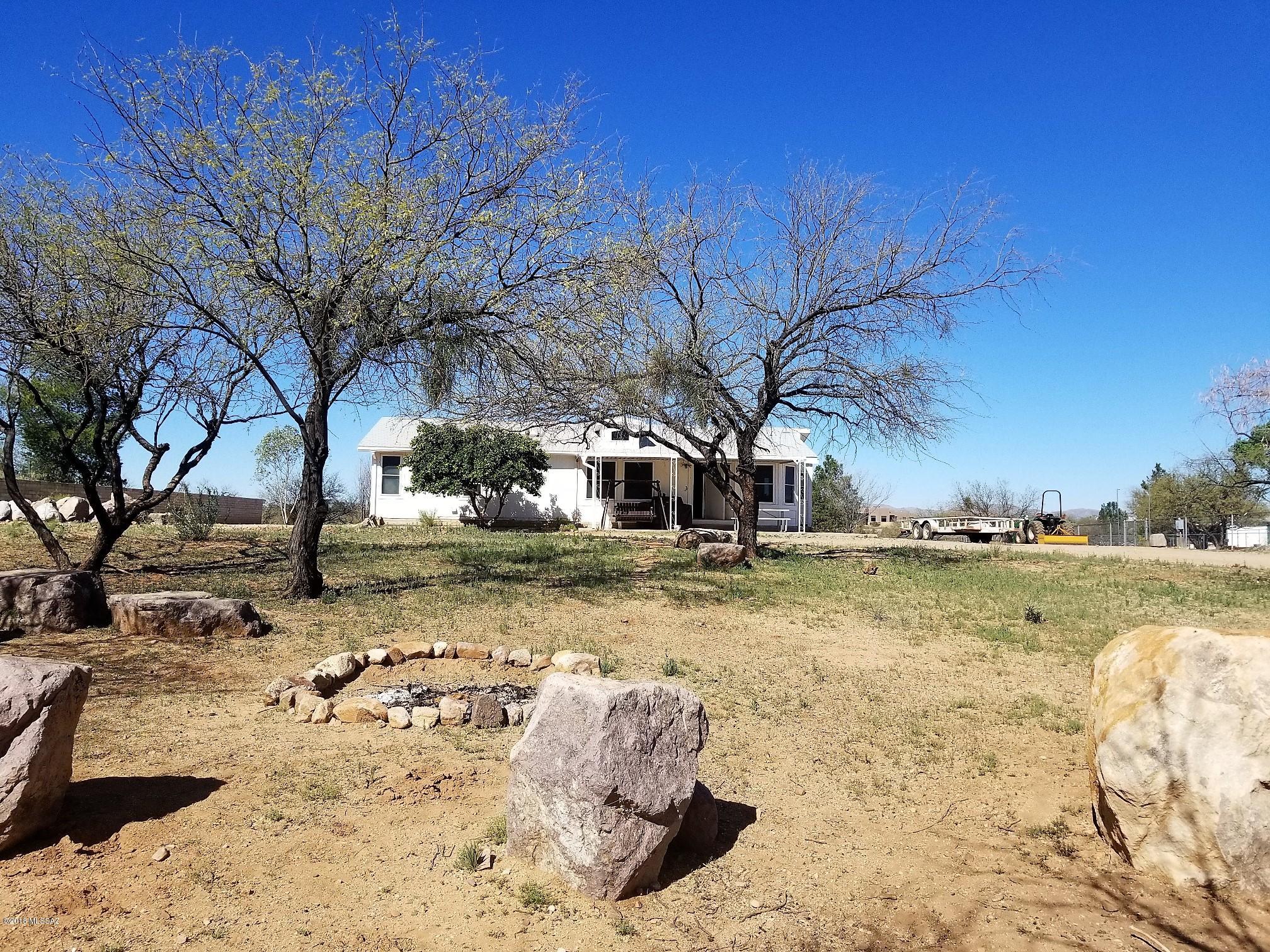 Wonderful 1.58 acre view lot with 1482 sq. ft. groundset home in Catalina. Home is in great shape and very affordable. Property has full RV hookup, plus space for horses, ATV's and any other toys you might have. Property is all useable. Completely fenced with electronic gate. HORSE CORRALS DO NOT CONVEY. Covered porches on front and back. Come see this today!