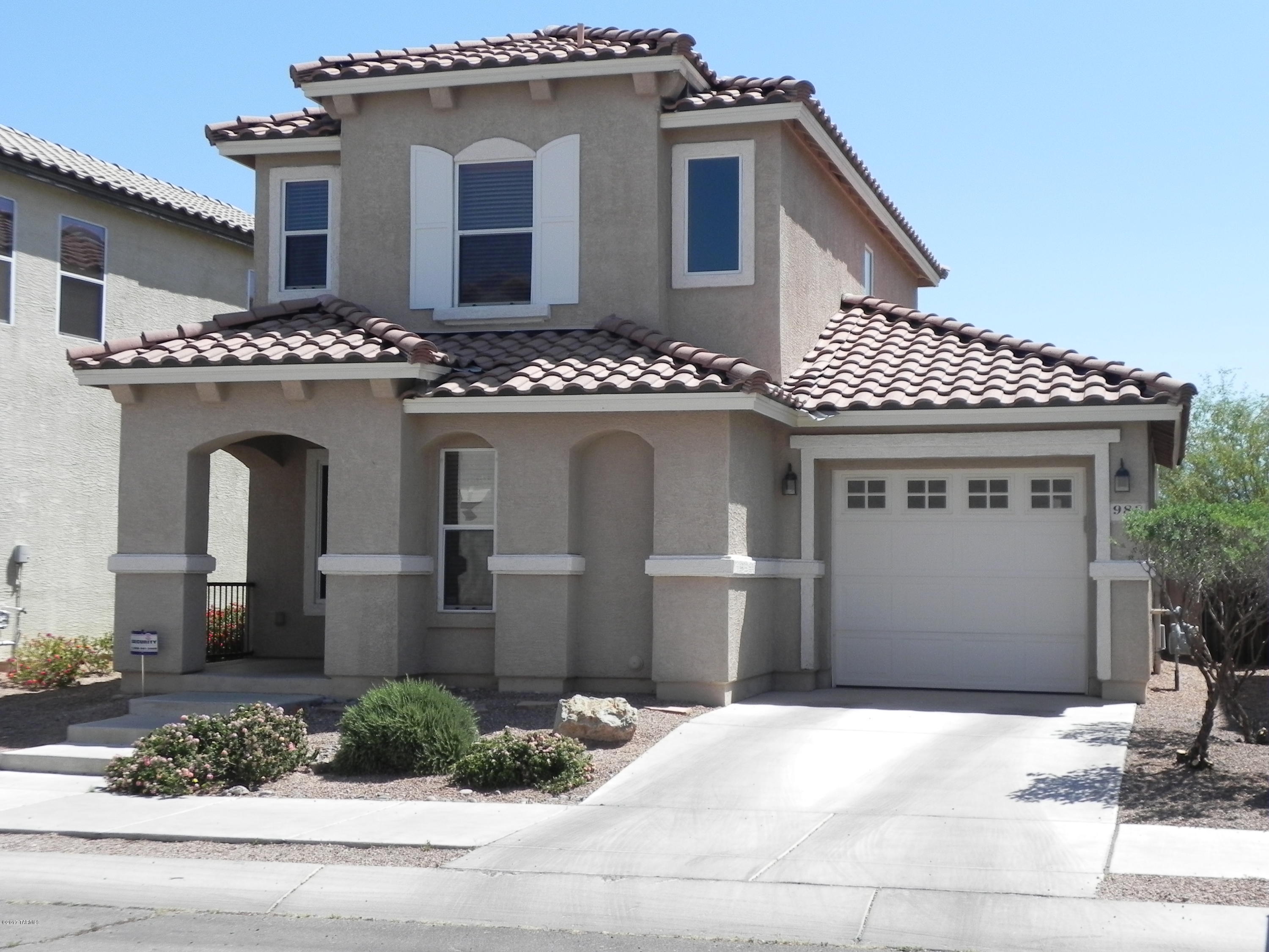 This beautiful 2 story, 3 bedroom home is located in the popular east side community of Pantano Overlook.  It has been upgraded and lovingly maintained with custom paint and 18 inch tile on the first floor and in the upstairs bathroom.  The open and bright eat-in kitchen features warmly stained cabinets with granite counters accented with black sink and appliances. This home backs to common area with sweeping mountain views and additional privacy.