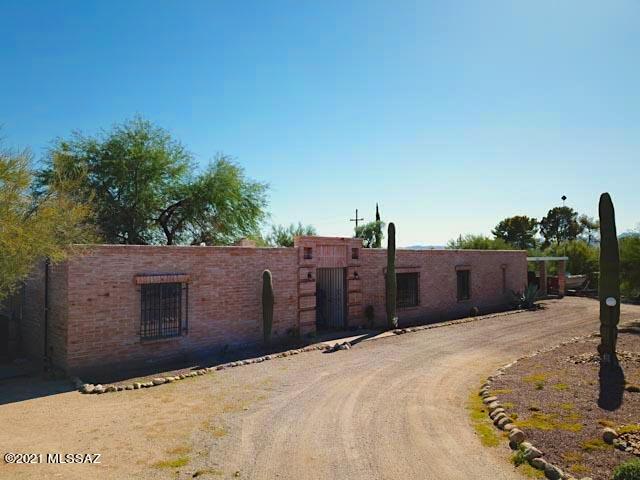 Gorgeous burnt adobe home situated on nearly an acre in Northwest Tucson! This home features 4 bedrooms, 2 bathrooms, a spacious living area, a separate open concept family room and a huge bonus room perfect for home office/craft room/game room or endless possibilities. Upgraded kitchen features gas cooking, SS appliances, and stylish granite counter-tops. Enjoy the incredible outdoor space that offers low care desert landscaping, a covered patio, breathtaking mountain views, and a sparkling pool. All within walking distance from schools, shopping & restaurants. Come take a look!