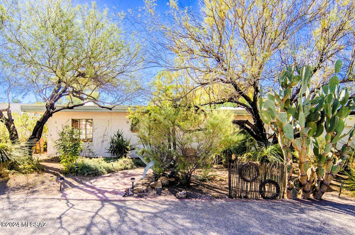 Gorgeous mid-century bungalow in San Clemente, on a quarter acre lot with mature trees and vegetation might be just what you are looking for!  Charming neighborhood, close to all of the good stuff:  restaurants, shopping, Reid Park, the Broadway Sunshine Mile corridor, easy commute into downtown! This home is spacious, with 3 bds, 2 full baths or use the small bedroom as an office. Hardwood floors, fireplace, loads of light, big windows, and the screened Arizona room looks out over the backyard oasis.    Small bedroom off living room could be playroom, or a study. This home oozes charm, and has been updated but still retains so much of the 1947 vibe. Call your agent or call me, to see it during the Coming Soon period.  Active status with Open Houses the weekend of the 20