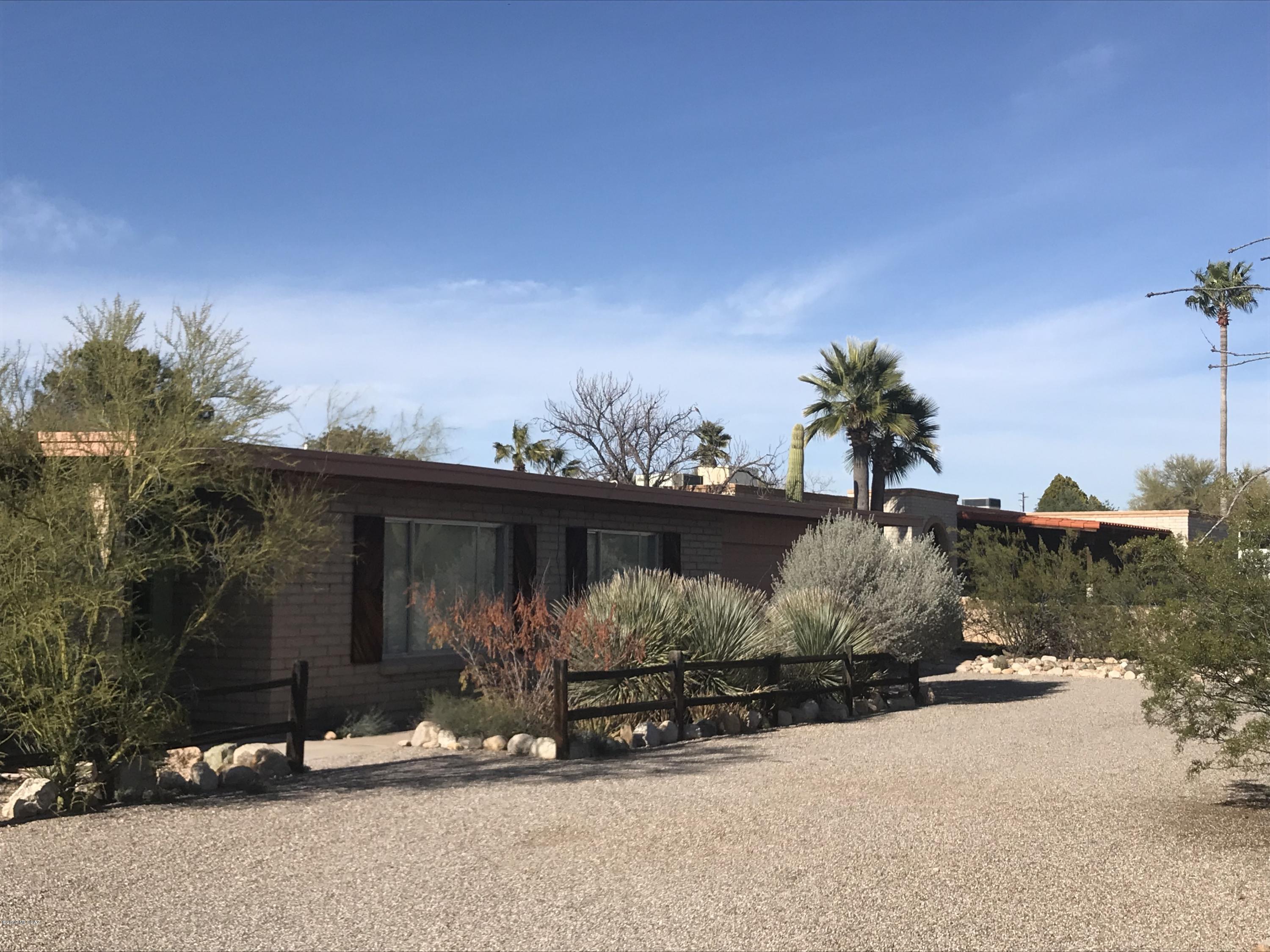 Huge home with .7 acres. Beautiful natural desert landscape and views of the Catalina's from the front yard. Natural desert landscape surround the large circular drive. From the moment you walk into this house you are greeted with unlimited potential. Over sized living room and formal dining room and a family room with eat in kitchen area. 4 bedroom with two baths. Laundry room with ample storage, attached garage with a workshop attached. This home is waiting for your creativity and personal touches.