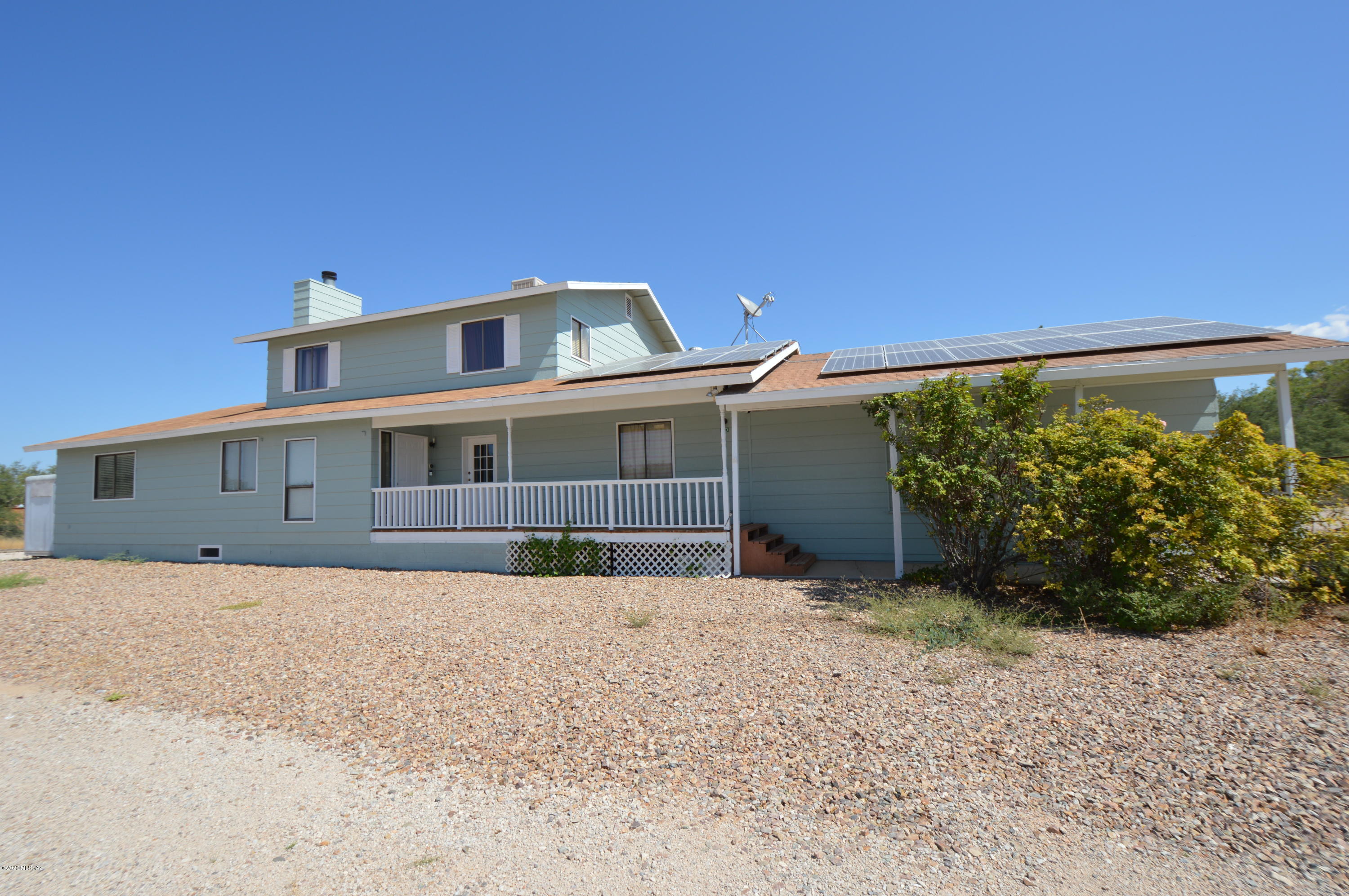 Looking for cooler weather in southern Arizona? Come check out this property! Sitting on just under an acre, this home boasts 6 bedrooms and 4 bathrooms. Equipped with a photo voltaic system your energy bills will be next to nothing throughout the year. Backyard has plenty of artificial turf to enjoy, along with a huge aquaponics setup ready for you to complete and utilize. Interior has a large galley kitchen, spacious living room and dining room. Master bedroom is on the main level and has a mini split HVAC system, large closet, and dbl vanity in the bthrm. Guest quarters are also on the main level that include a bedroom with walk-in closet, private bathroom and small living room. Guest quarters have private entrance and could easily be used as a home office. Commercial aquaponics farm needs to be completed by Buyer. Photovoltaic system is a 6.4kw system and is owned.
