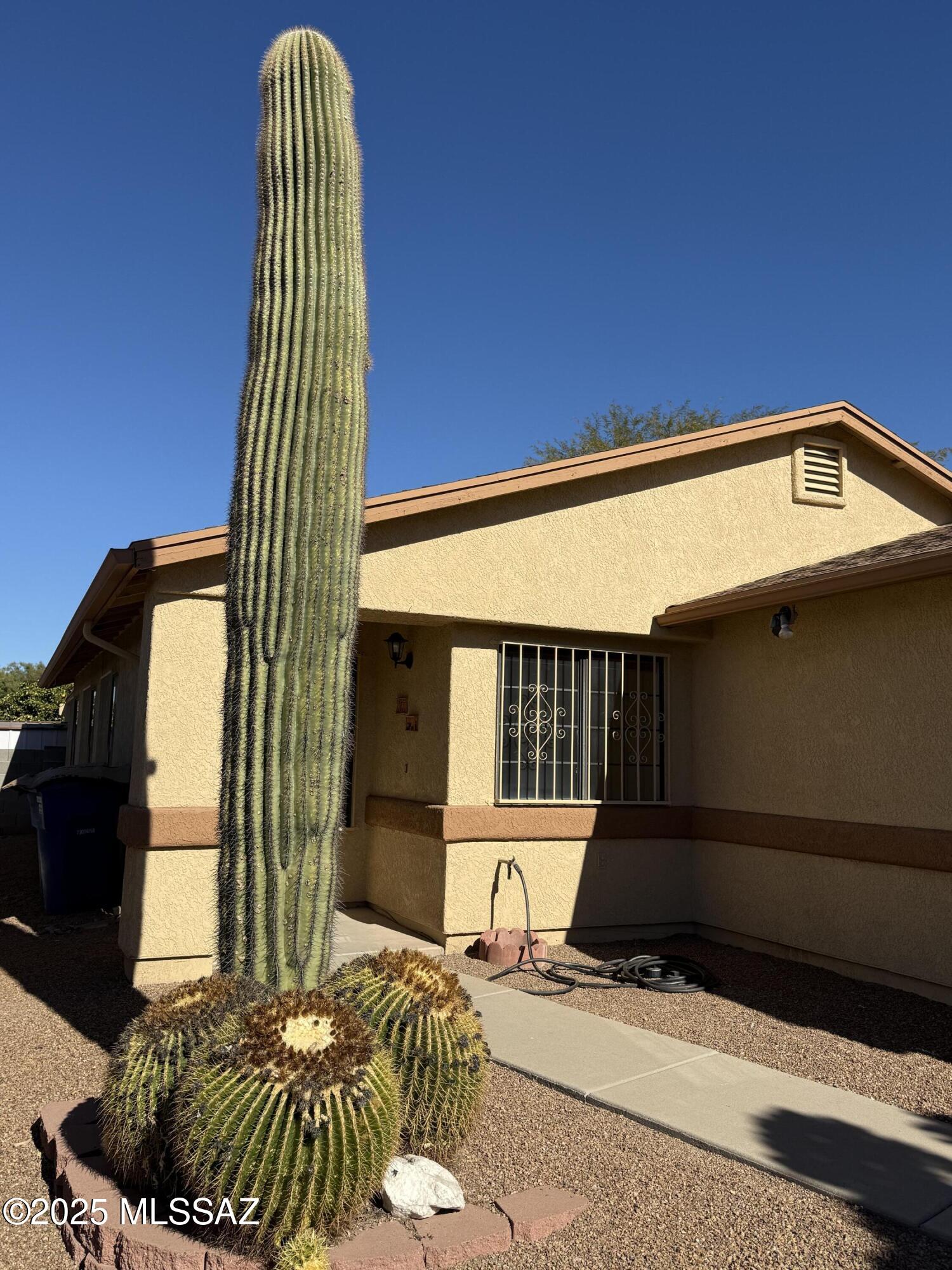 Well-maintained, light-filled open floor plan with vaulted ceiling in great room and separate area for den or office. Tan carpet throughout with vinyl tile in foyer and kitchen. Large closets. 2-car garage. Wrought iron on all windows and doors. Private backyard with covered patio and two storage sheds. Established neighborhood.