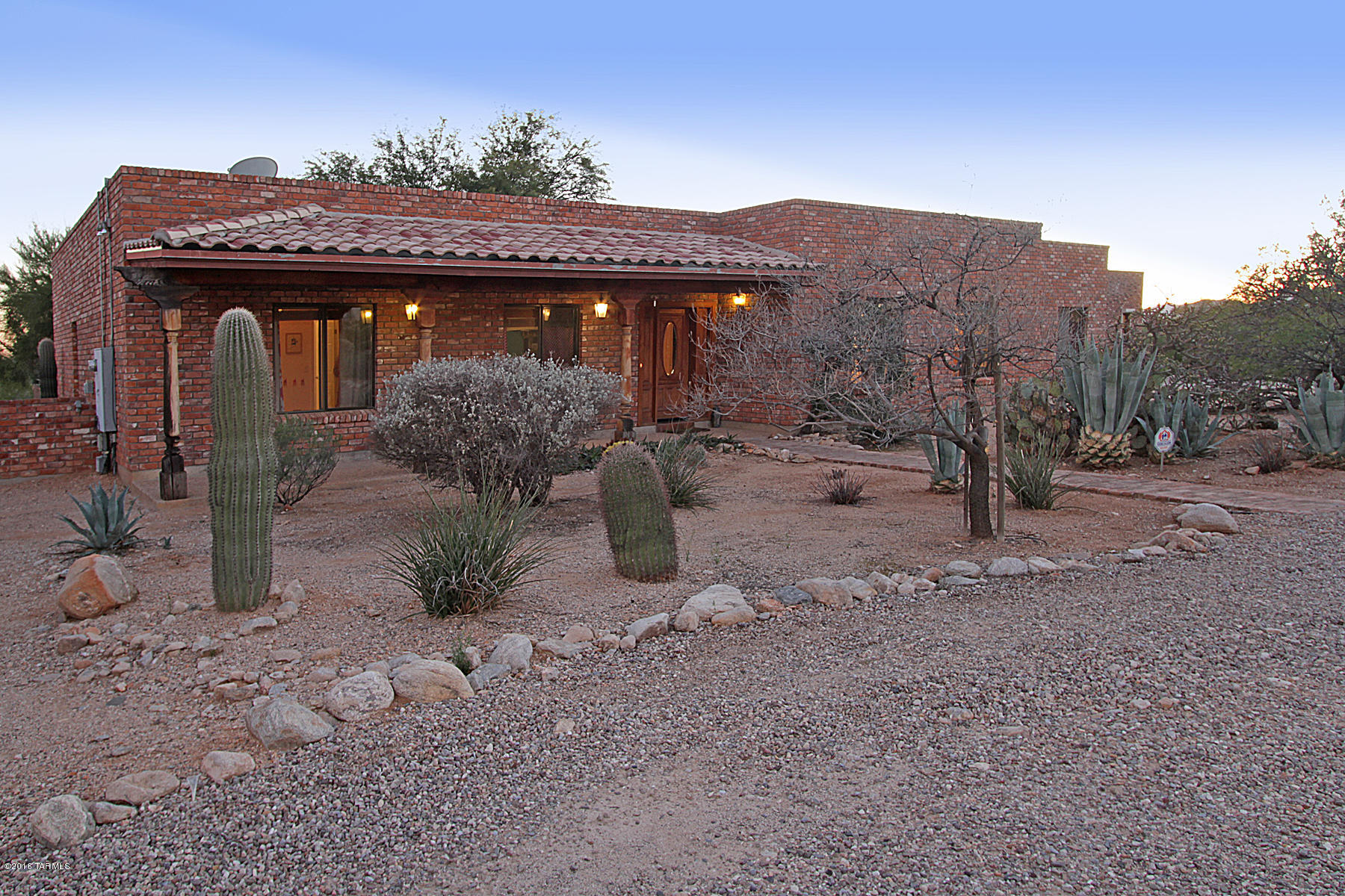 Modern but Cozy Brick Territorial Private Artist Retreat w/detached Guest House/Studio in Gorgeous Catalina Foothills neighborhood of Shadow Hills. Main house is 2401 sq ft with high ceilings-5 skylights so bright & airy- 3 bedrooms-2 full baths-bamboo floors, open/light/bright-intimate kitchen & dining area w/fireplace-large master suite w/fireplace-large Den/office or rec room-District 16 Schools-dramatic Mountain-City lights-Desert views & Pool. GH built in 2000 by Page Repp-646sq ft-large open floor plan-scored concrete floors-skylights make it light & bright-french doors w/covered patio. 1 bedroom & full bath.  Lg, private-multi-view .89 of an acre lot w/mature landscaping. This is a unique property-set way back from street for ultimate privacy & desert feel uncommon in Shadow Hills!