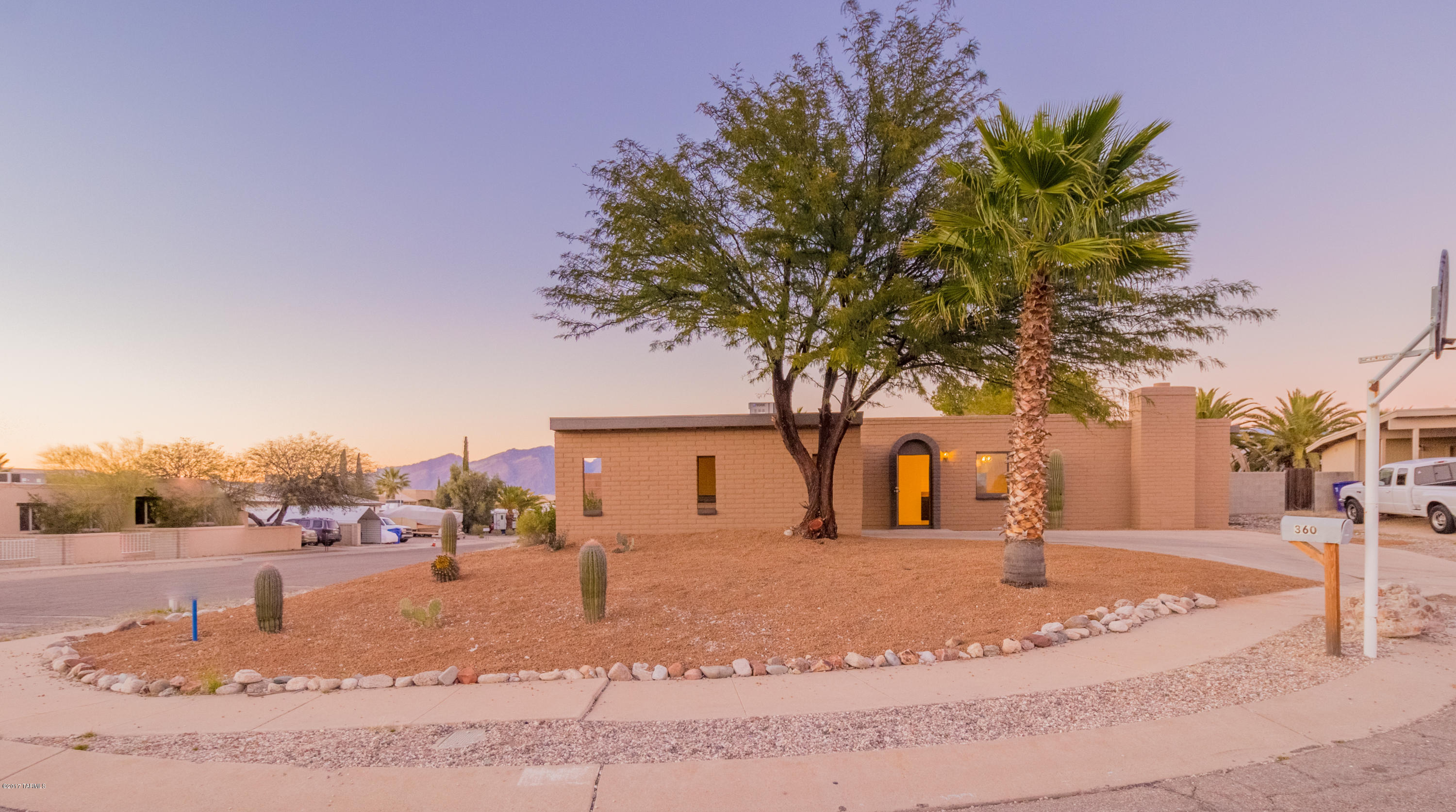 Spectacular updated home with wide mountain views on a corner lot. This 3 bedroom & 2 bath home features a open floor plan with a living room/great room and an additional den/family room with a fireplace. A big laundry room with new hot water heater. New appliances, dual pane windows and more! Great area that is close to everything and friendly neighbors. Very popular area! Call, text or email today for a showing. A member of  Tucson Acquisition & Dev. Corp is a licensed Realtor in Arizona.