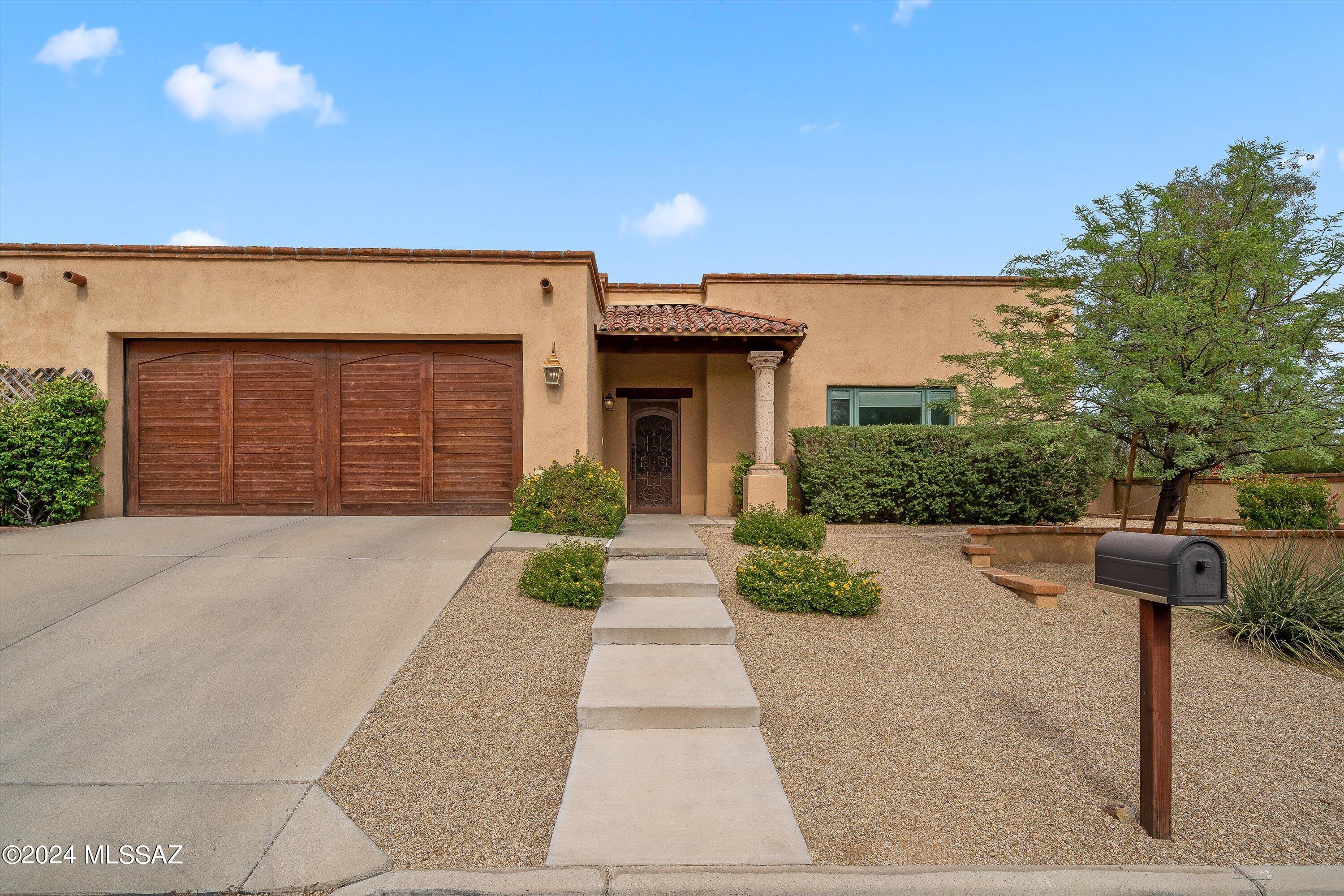 Semi-custom LUXURY HOME is one of only 4 higher-end homes built within this gated 20-home community. Charming 3BD/2BA (2,002 SF) corner lot home boasts RASTRA construction, high ceilings, Travertine floors, 8' solid wood doors, Pella windows and ceiling speakers. Gated, tumbled stone courtyard flows to living-dining room w/ Cantera stone FP. Gourmet kitchen hosts center island w/skylight, granite counters and Viking fridge/gas range. Private Owner's suite off courtyard hosts luxury bath w/dual sink vanity, walk-in shower, custom closet. Guest room plus office/2nd bedroom w/bookshelves, closet & rear patio access. Garage storage plus newer HVAC/water heater. Enjoy a tranquil rear yard featuring covered stone patio, flowering shrubs and mature shade trees.