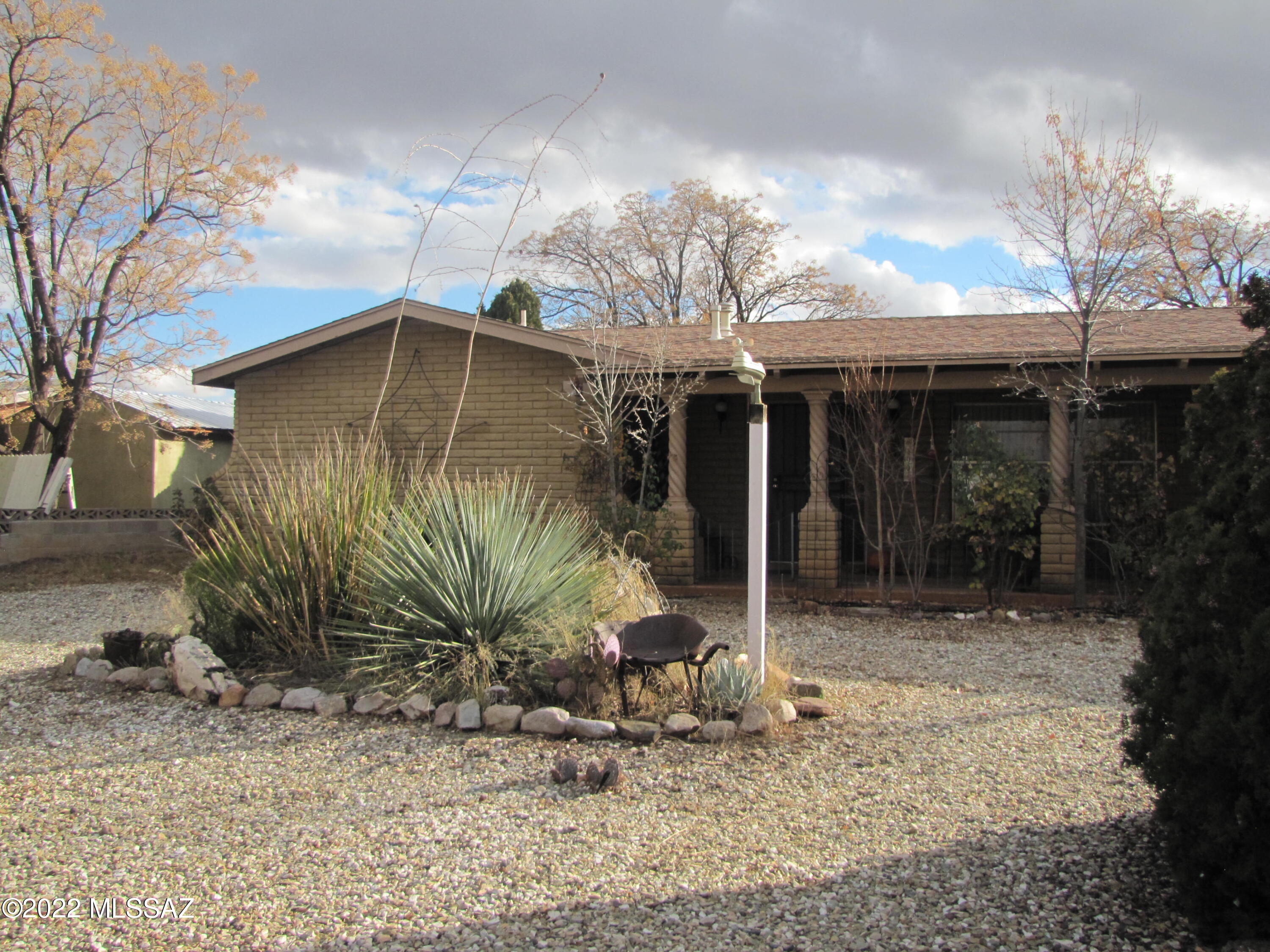 Slump block 3BR/2Ba home located near the heart of Sunsites. Welcoming covered front porch. Formal living room and dining room. Split bedroom plan. MBR suite has 3 closets. Custom tile in MBa shower. Wood burning fireplace in family room. Kitchen and breakfast nook filled with natural light from bay window. Laundry area with lots of extra storage and doors to backyard and garage. Sliding door from family room into AZ then private fenced backyard. Two car garage and mature landscaping both front and back.