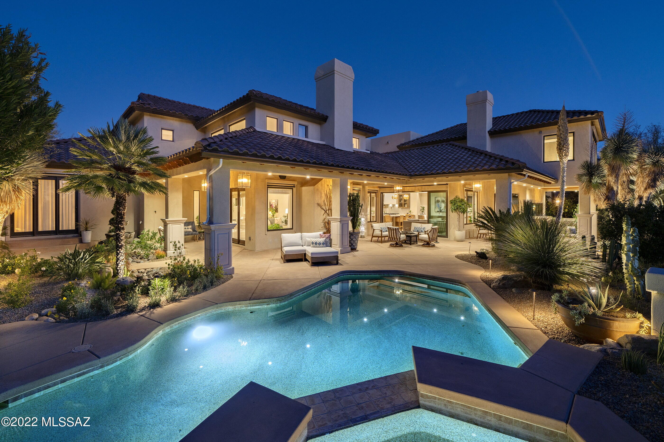 Situated on a commanding view lot overlooking the greens of the Ventana Country Club's 9th fairway, this adaptive remodel demands privacy while preserving views that open out to far reaching vistas of the adjacent Catalina Mountains. An exclusive property that exemplifies timeless architecture, juxtaposed against modern interior design, features generously proportioned rooms, paired with a thoughtful floor plan that is perfect for entertaining, as well as casual everyday living. This sensitive and ambitious remodel (completed in 2022) was overseen by renowned Portland, Oregon design firm Vida Design and constructed by acclaimed builder John Kline, retains the essence of the original architecture, whilst creating a renewed vision of amenities and services an owner would expect from... a home of this caliber.

Upon approach one is received by a private entry courtyard, featuring a cohort of lush vegetation conceived by notable landscape architect Rob Vincent that celebrates the natural beauty encompassing the residence. As an introduction to the home's effortless blend of open concept and laissez-faire, the entry foyer sets the stage for the innovative design that unfolds throughout the property. The home's interior features the highest quality materials, adorned with european white oak wood Levanto flooring, dressed in a marble inlay, with interiors that complement a cohesive blend of custom styling and finishes throughout.

The kitchen's disciplined design features Grey Washed Alder Modern Shaker cabinets, fitted with a combination of Mont Blanc Quartz surfaces, housing a Pro-Series Viking and Sub Zero appliance package. Centrally located, the kitchen looks North to walls of retractable glass, providing a horizontal relief point that spills out onto the wrap around veranda, fusing the home's indoor/outdoor lifestyle.

Exceptional entertainment continues in the dedicated media room, capturing pieces of the theater experience, with walls draped in a stunning Kate Blairstone Tigris Wallpaper, setting the mood, while allowing versatility in its use to reflect the activities enjoyed by its owner. Integrative cutting-edge technology that utilizes a tablet interface for whole house automation and sound, with security and camera monitoring capabilities, all available at the touch of your fingertips.

The home's second level comprises the Owner's Suite, as well as two of the three secondary en-suites, and is accessible by independent staircases that flank the primary level public spaces. The Owner's Suite is sequestered on the far Southwest end of the residence, with a custom dressing closet, and a luxurious bath assembled with top end fit and finish. Large floor to ceiling windows fill this primary suite with soft natural light, capturing views of the surrounding tree canopies, sweeping out over the Catalina Mountains. An oversized fourth ensuite is housed on the Northwest end of the main level, perfect for guests, or multi-generational living, making this adaptive floor plan ideal for myriad of living options.

Seamless indoor-outdoor entertaining, connects the shared living spaces, with a series of doors coordinated to tie the interior rooms to the spacious outdoor living environments. Layers of elevated patios create the framework for the salt water pool and elevated spa, acting as the centerpiece of the backyard entertainment, where every comfort has been considered and detail meticulously crafted, the result being a home that offers a sense of ease to enjoy the Arizona lifestyle.

Ultra-privacy meets convenient proximity to all of life's necessities. Just moments away from hiking and biking trails, shops and restaurants, as well as the exclusive Ventana Country Club, offering 36-holes of championship golf, an elite tennis program, a resort and a lap swimming pool, and features a members clubhouse with dining and lodging for member's guests.