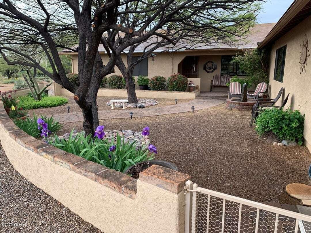 Magnificent unique custom home on private 1.39 ac horse property in quiet area is a must see, extremely well-maintained w/pride of ownership. Value-added amenities/features include an open & welcoming Great Room w/fireplace, formal & breakfast dining areas adjacent to wonderful kitchen, 4 split bedroom plan w/2 Master bedrooms (huge added Master suite is very special, gas fireplace & sitting area, Master bath w/double shower & separate jacuzzi tub), 3 full bathrooms+half bathroom accessible to outside/pool area, lots of storage closets, gigantic laundry room w/cabinets, giant 3.5 car garage w/built-in storage, workbench & pull down stairs to attic storage area, gorgeous self-cleaning swimming pool w/solar heater & waterfall, 4 covered patios+gazebo, and lush irrigated landscaping w/TREES!